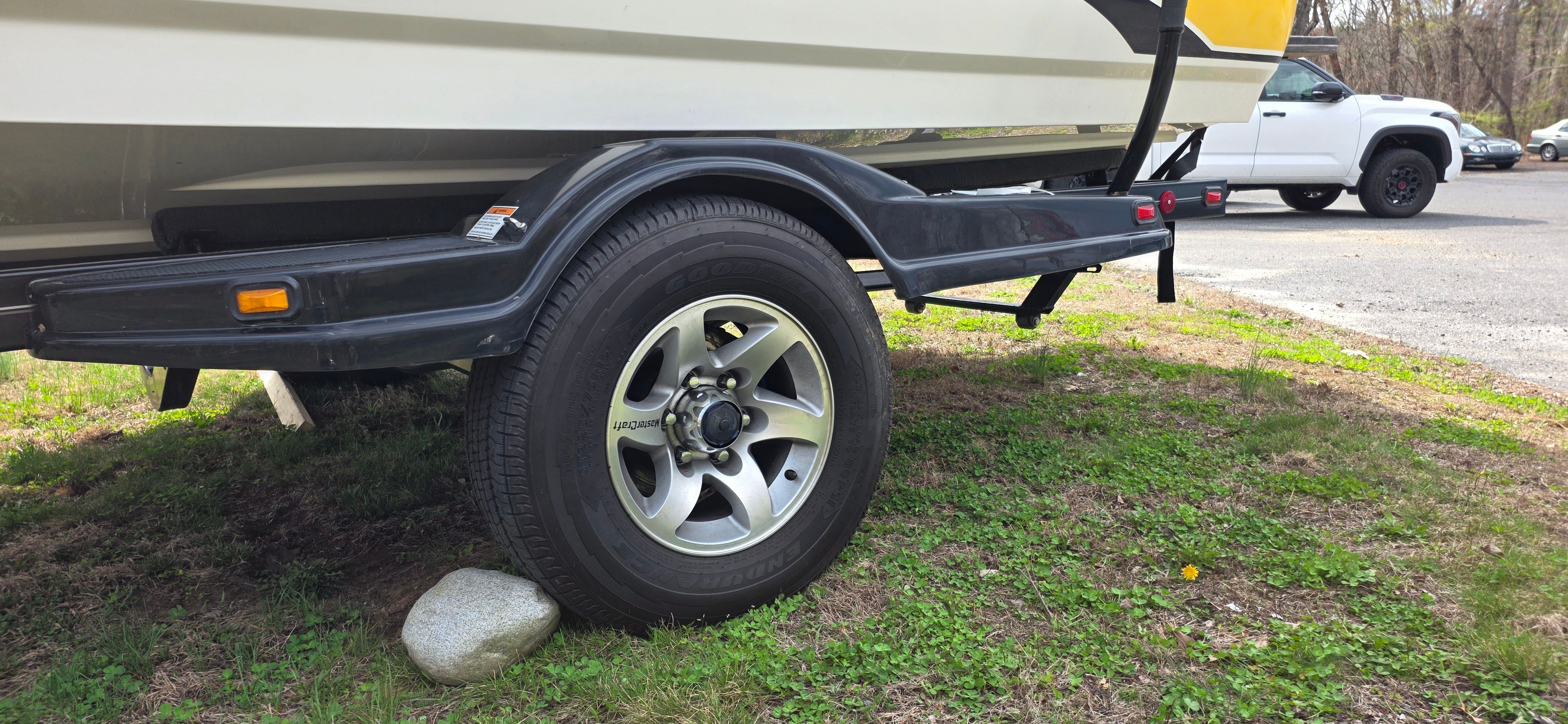 2004 MasterCraft Maristar boat trailer parked on grass.