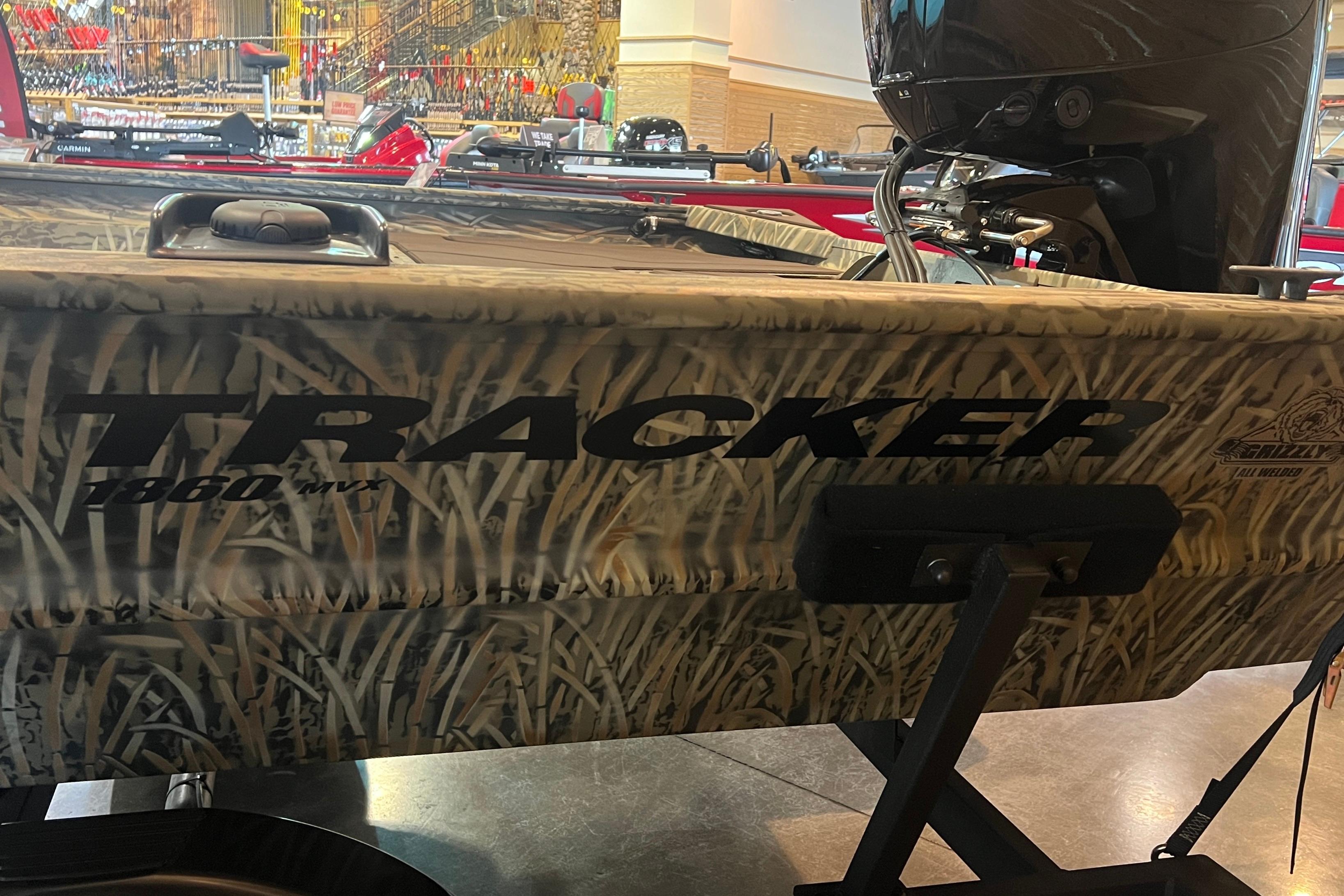 2026 Tracker Grizzly 1860 CC boat with camouflage design on display.