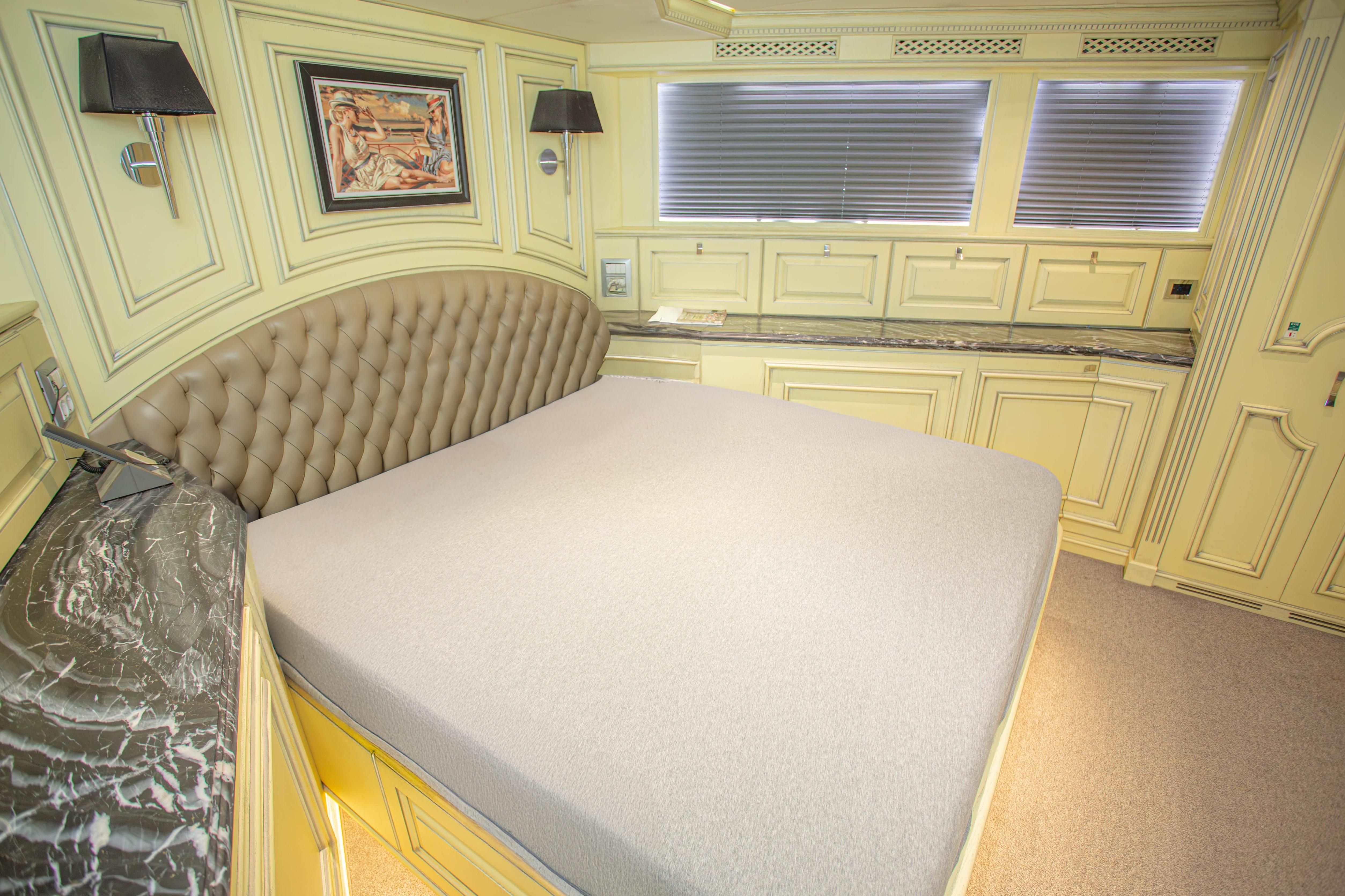 Luxurious bedroom interior of 2014 Fifth Ocean Yachts 24m Explorer Yacht with elegant decor.