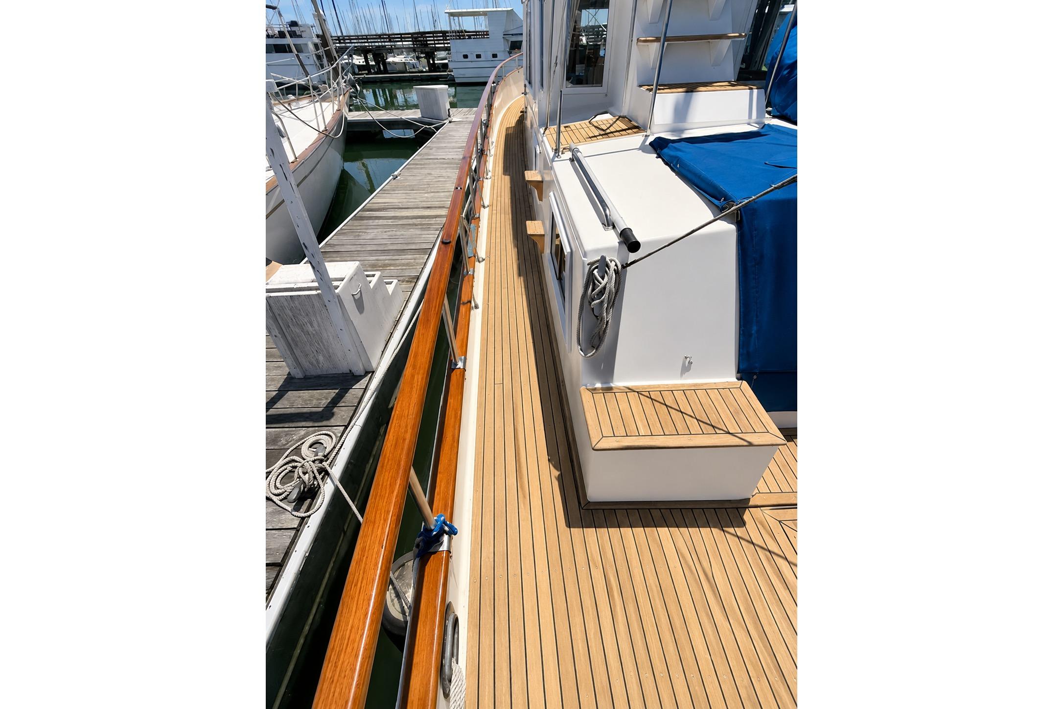 1989 Grand Banks 42 Classic yacht with teak deck at marina.