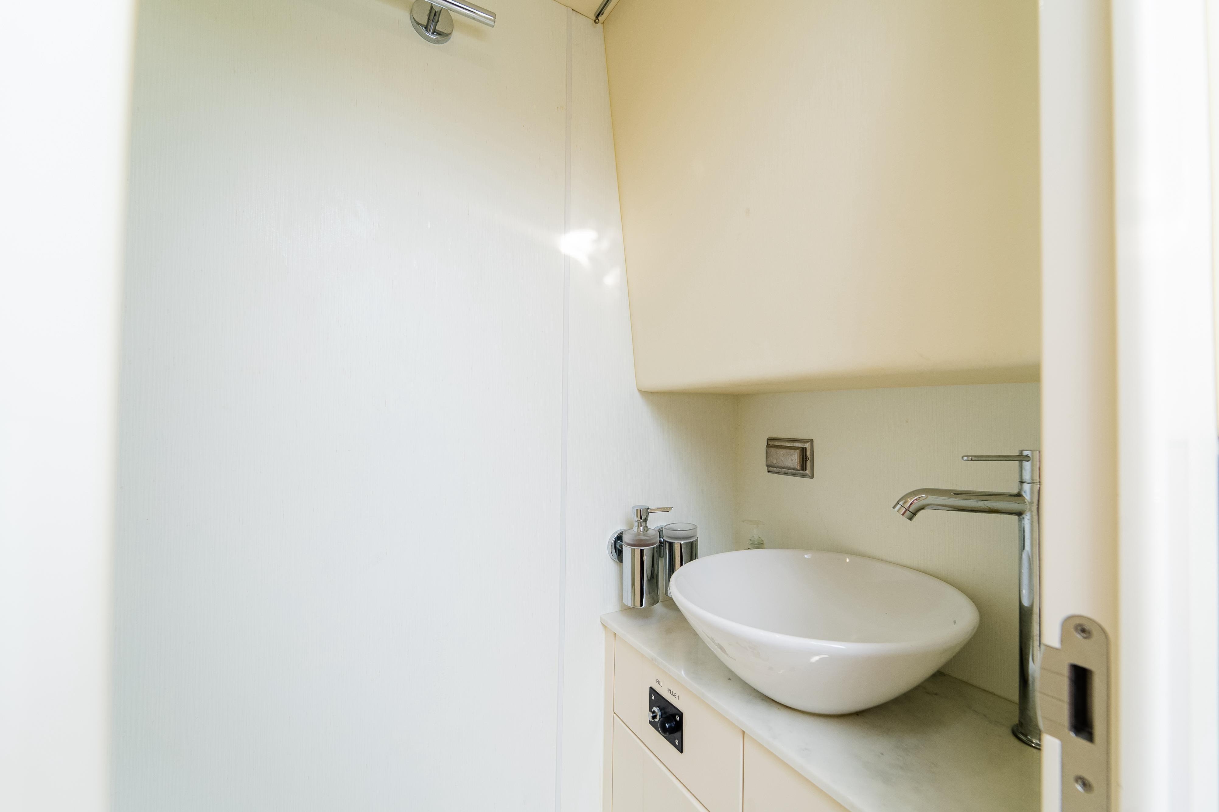 Modern bathroom sink in 2016 Sunseeker Manhattan 65 yacht, featuring sleek design and fixtures.
