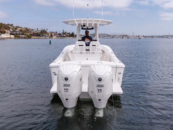 2025 Regulator 28 boat with twin 300 HP outboard engines on calm water.