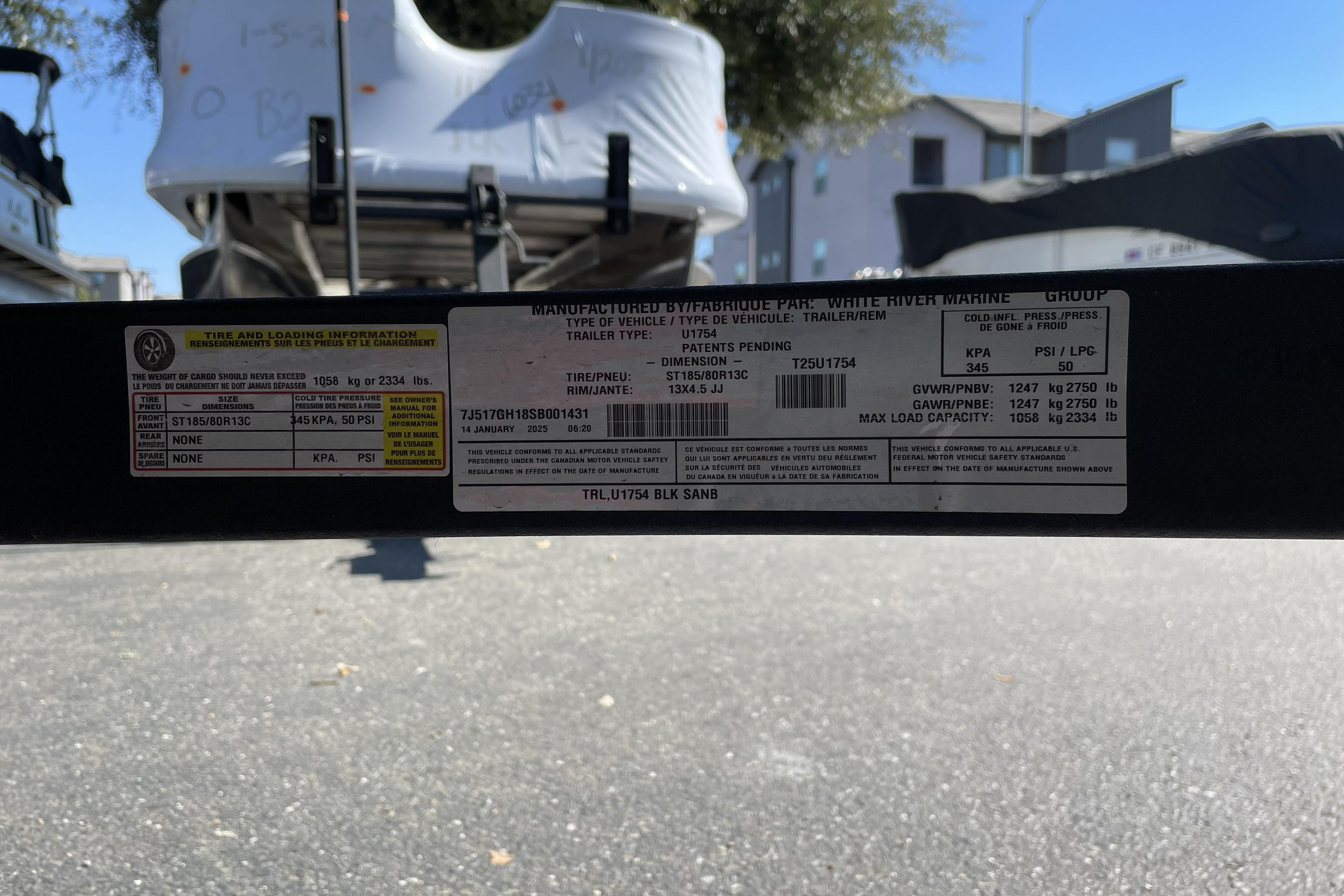 2025 Tracker Grizzly 1754 Jon trailer label with specifications and load information.