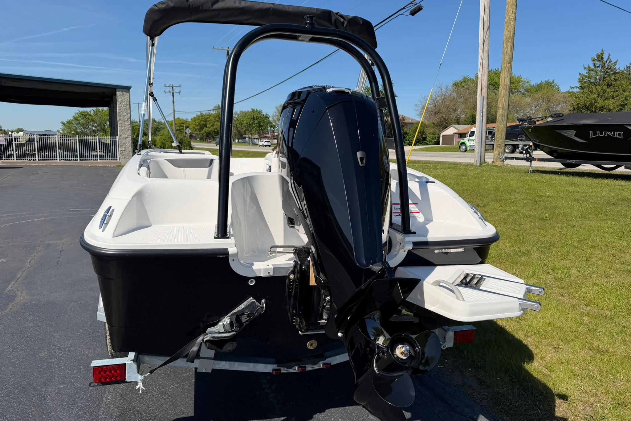 2026 Bayliner Element E18 boat with outboard motor, parked on a sunny day.