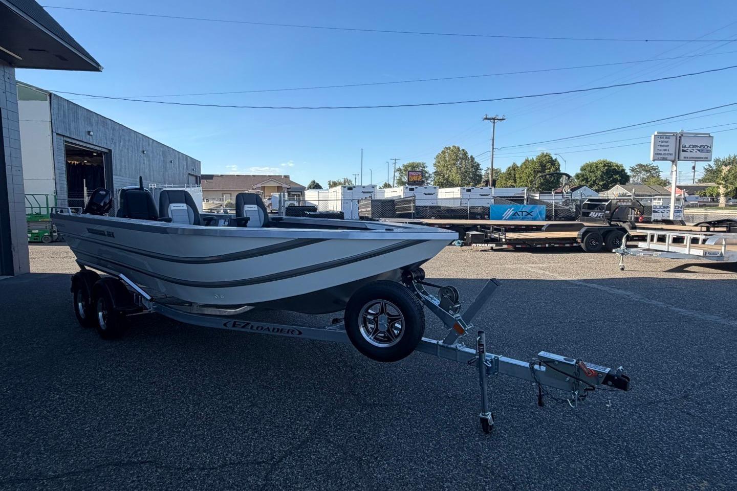2026 Thunder Jet 209 Rush OT boat on trailer in parking lot.