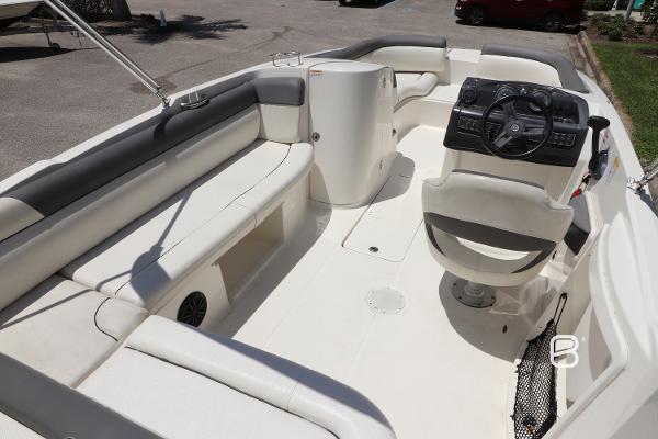 2018 Bayliner 210 DB boat interior with seating and steering console.