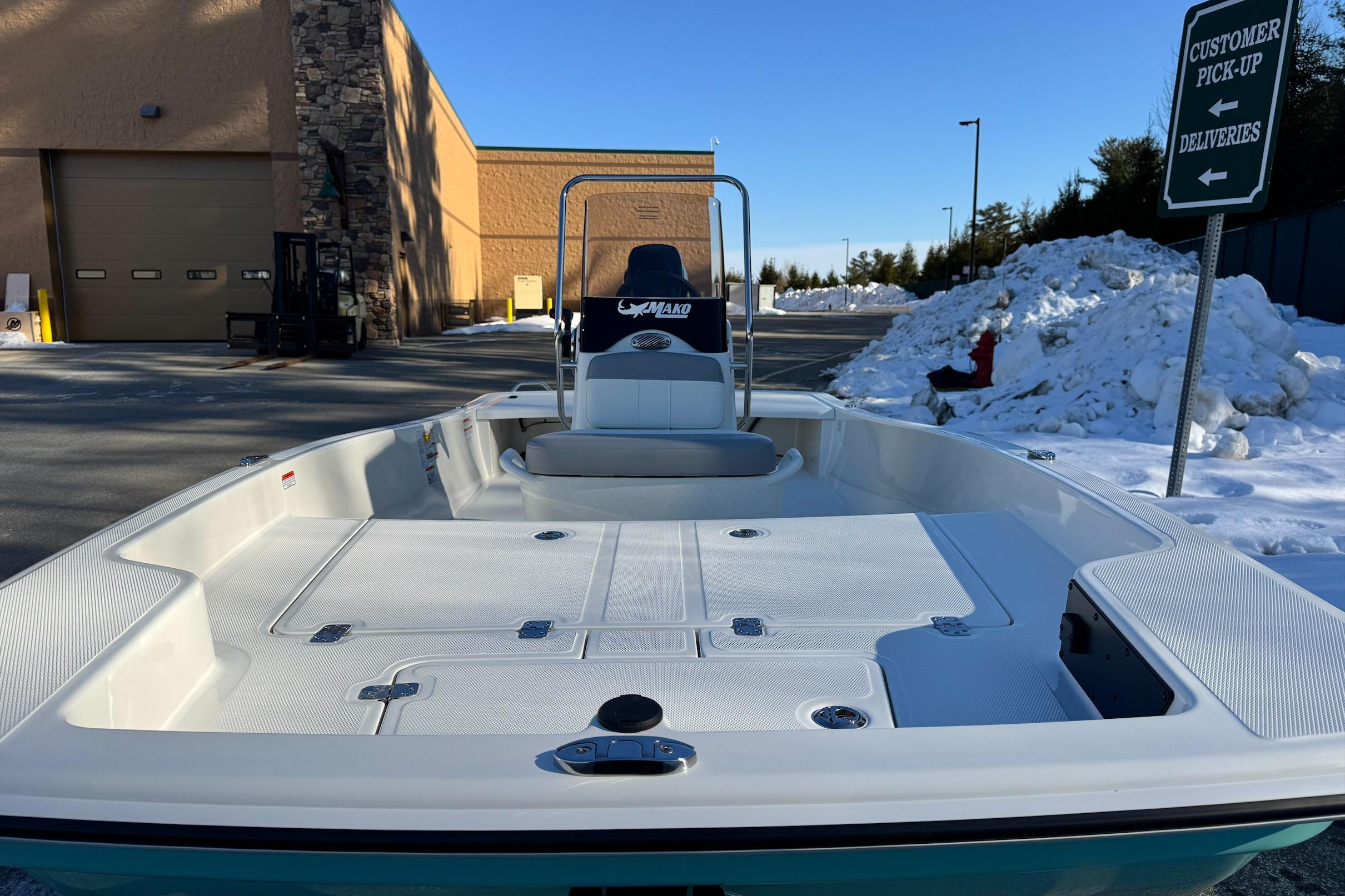 2026 Mako Pro Skiff 15 CC boat in snowy parking lot near customer pick-up area.