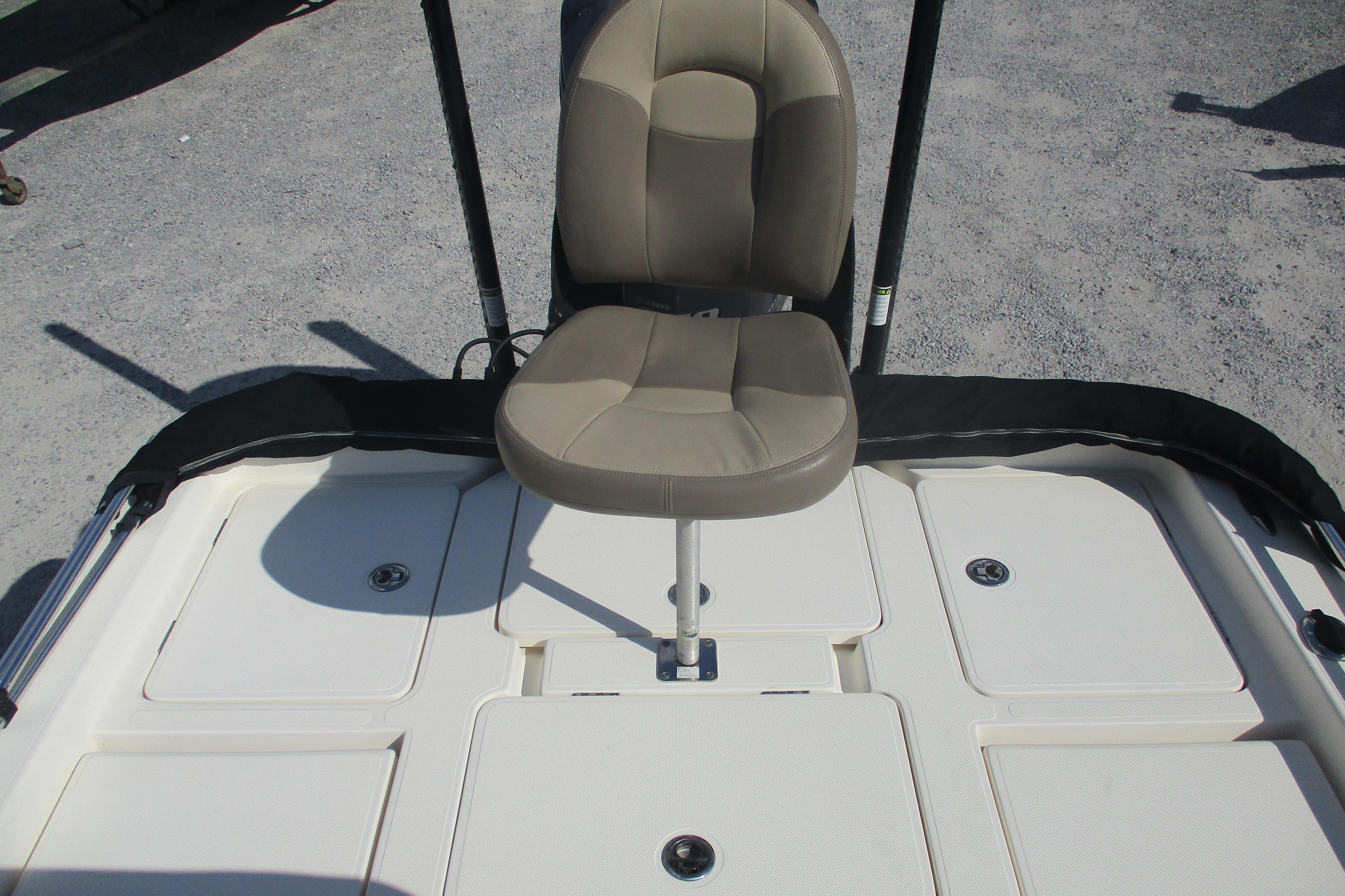 2014 Skeeter SX240 boat seat and deck, featuring beige upholstery and storage compartments.