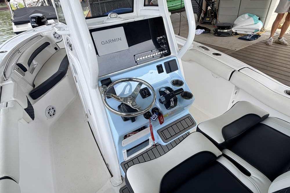 2024 Tidewater 232 LXF boat interior with Garmin navigation system and sleek steering console.