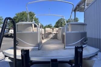 2012 Avalon Tahoe pontoon boat with spacious deck and seating, parked outdoors.