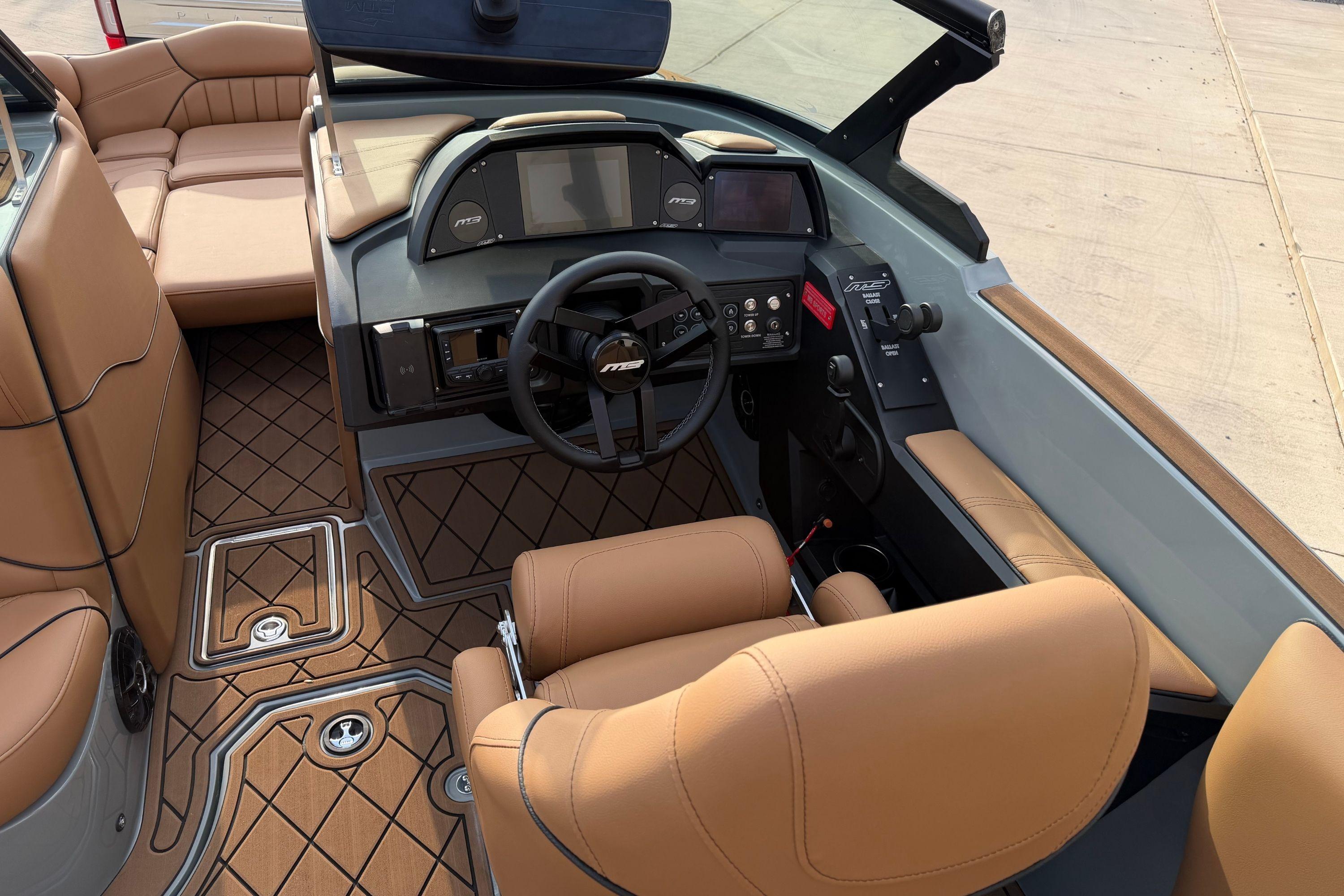 2026 MB B52 21 Alpha boat interior with tan leather seats and modern dashboard.