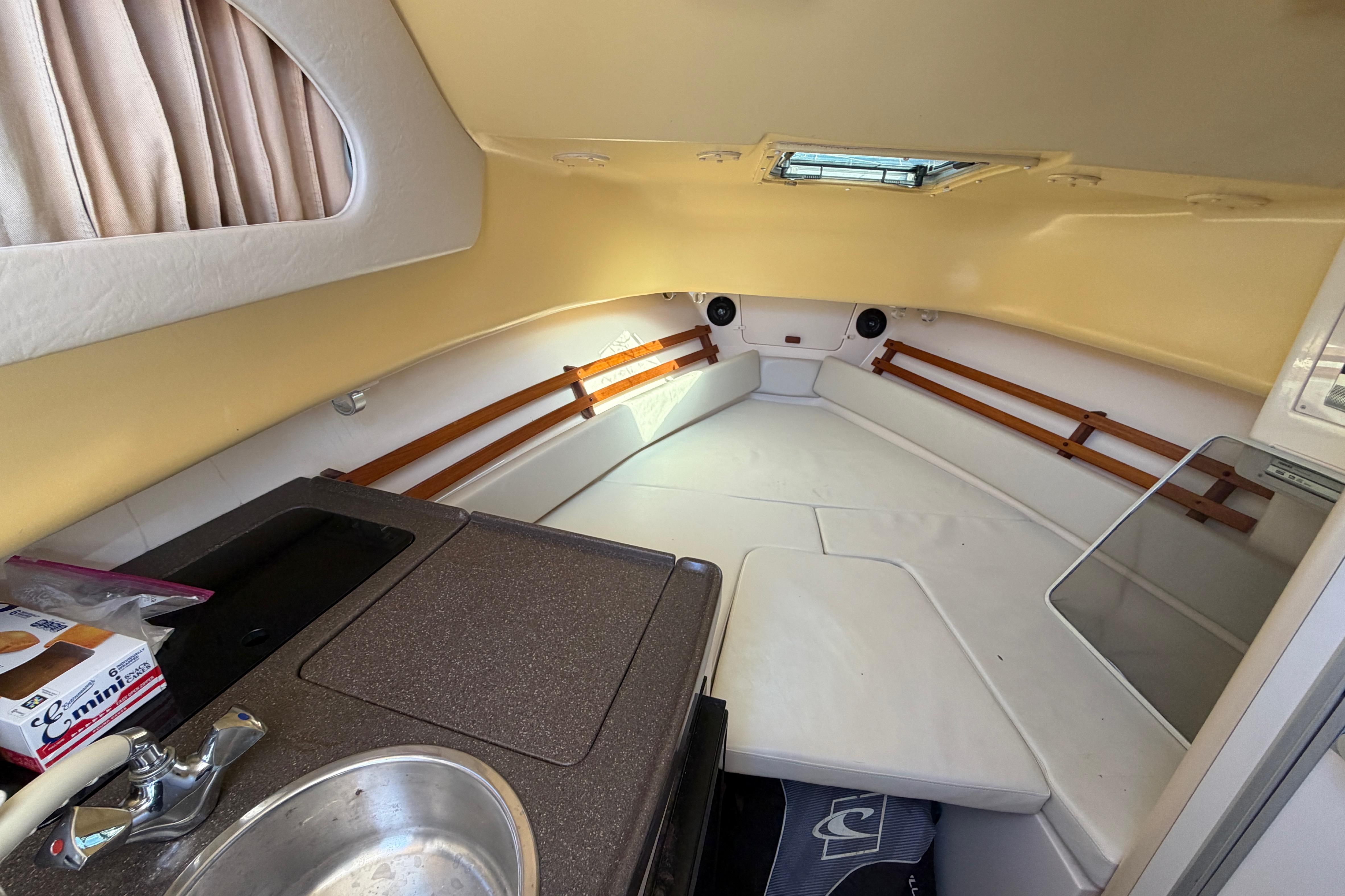 2006 Grady-White Sailfish 282 cabin interior with kitchenette and seating area.