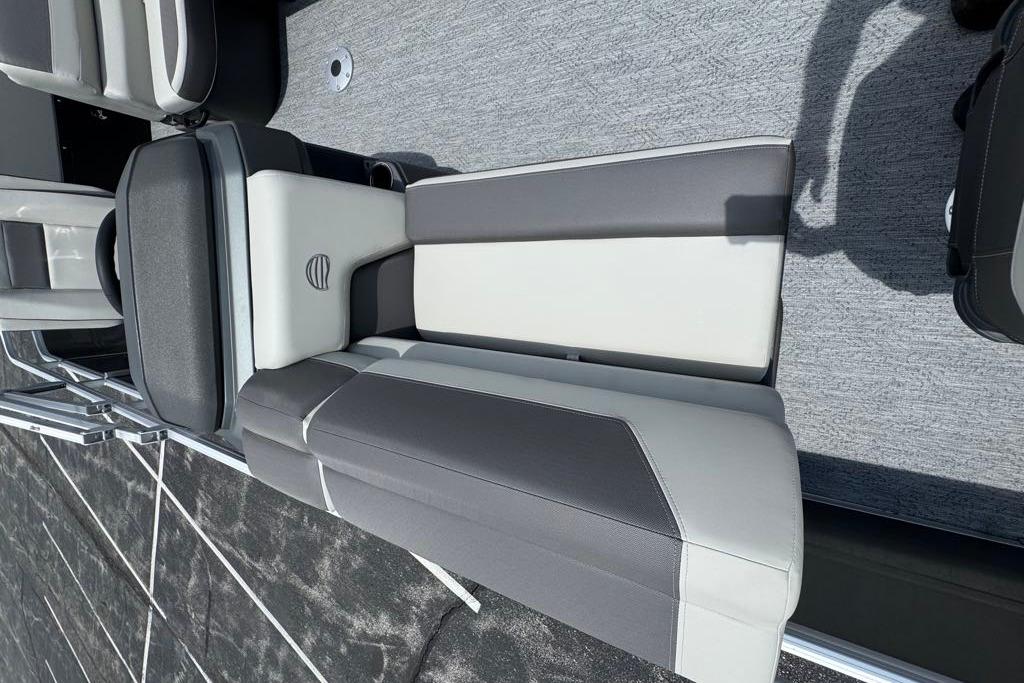 2026 Sun Tracker Fishin' Barge 20 DLX interior seating with gray and white upholstery.