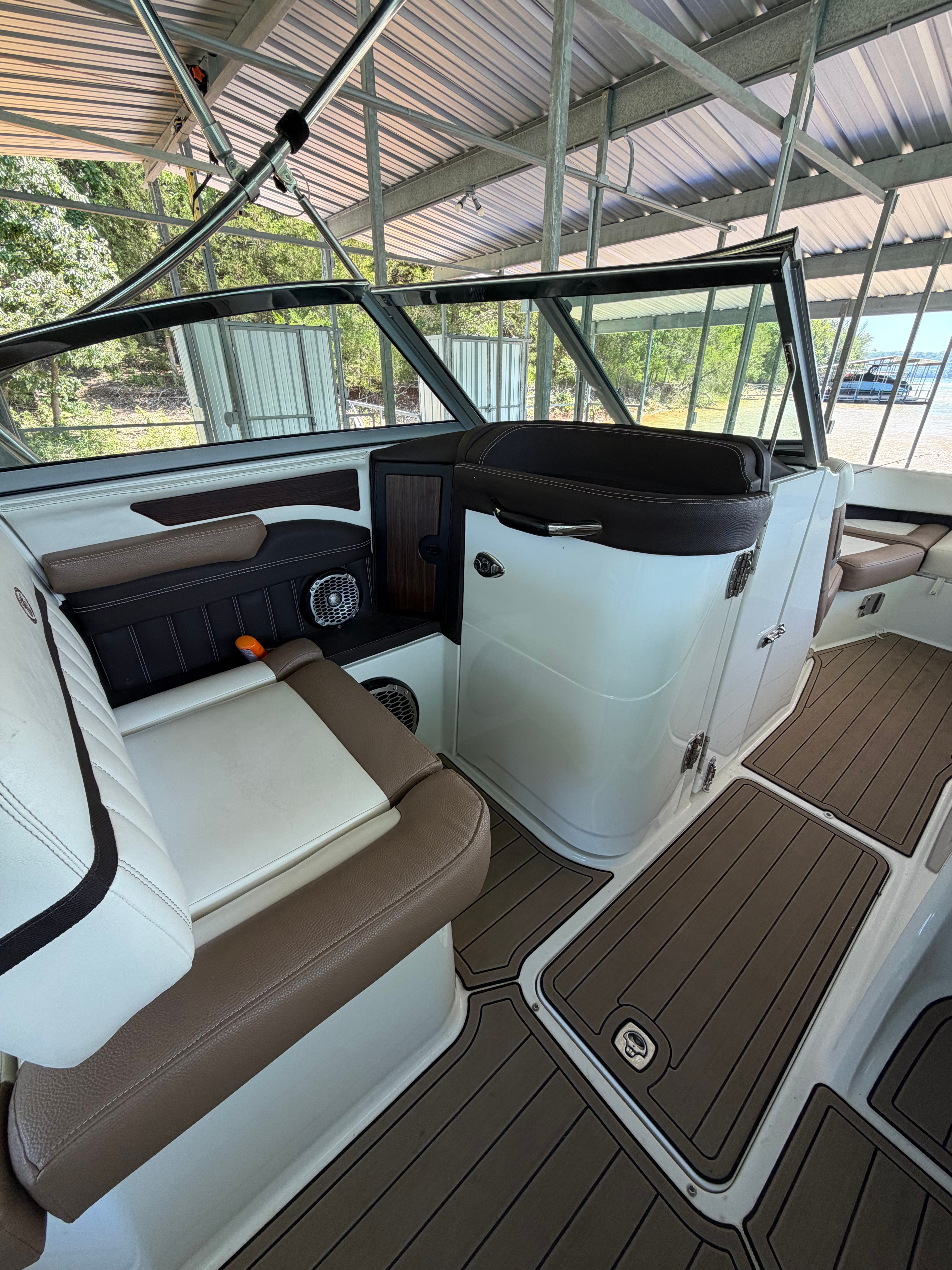 Interior of a Cobalt boat with seating and helm area.