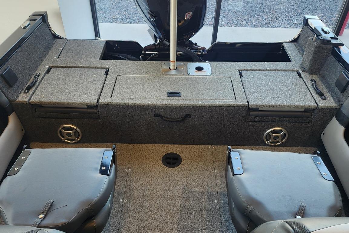 Interior of a 2023 Lowe boat featuring seating and storage compartments.