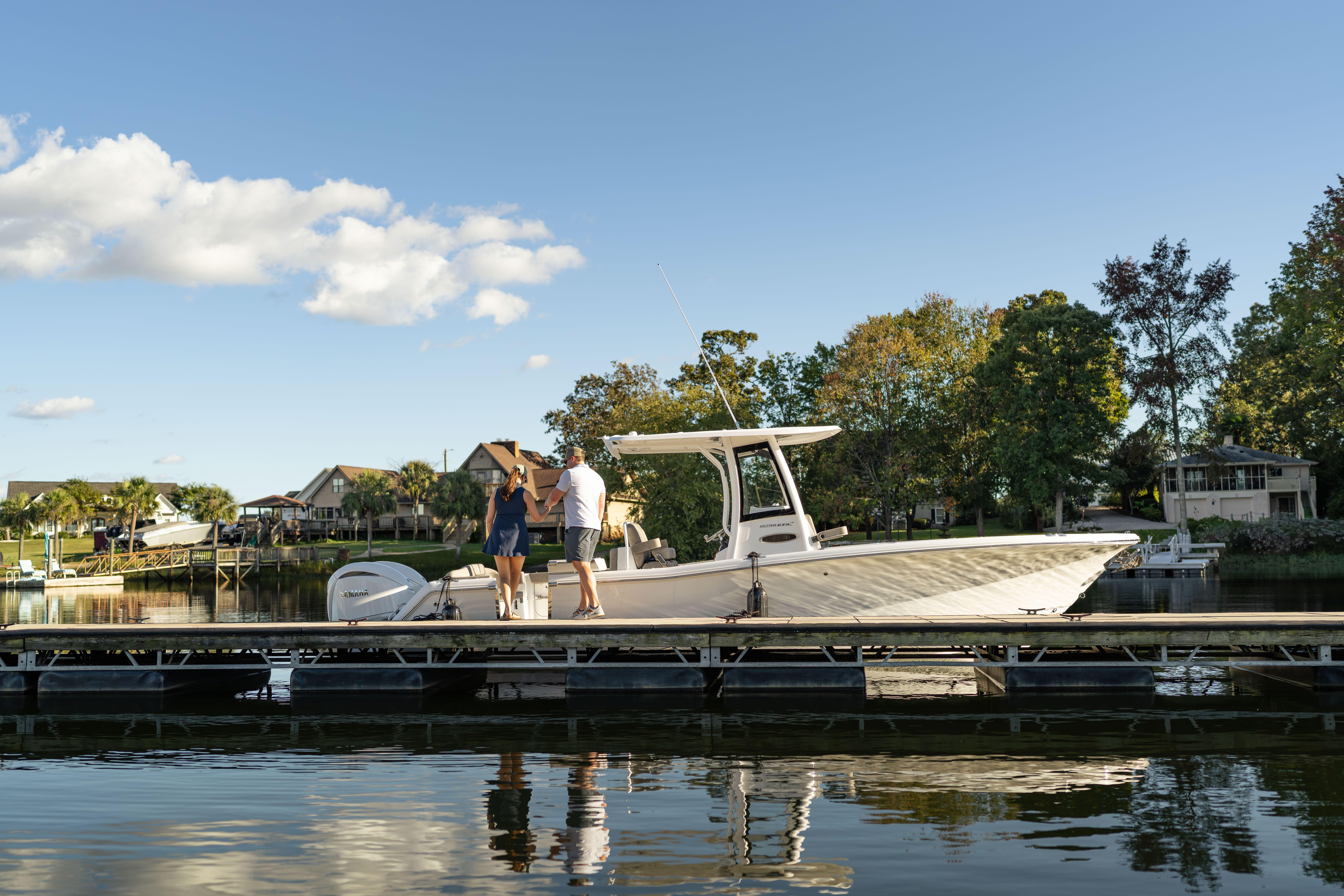 2026 Sea Hunt Ultra 275 Coffin Box boat docked on a sunny day.
