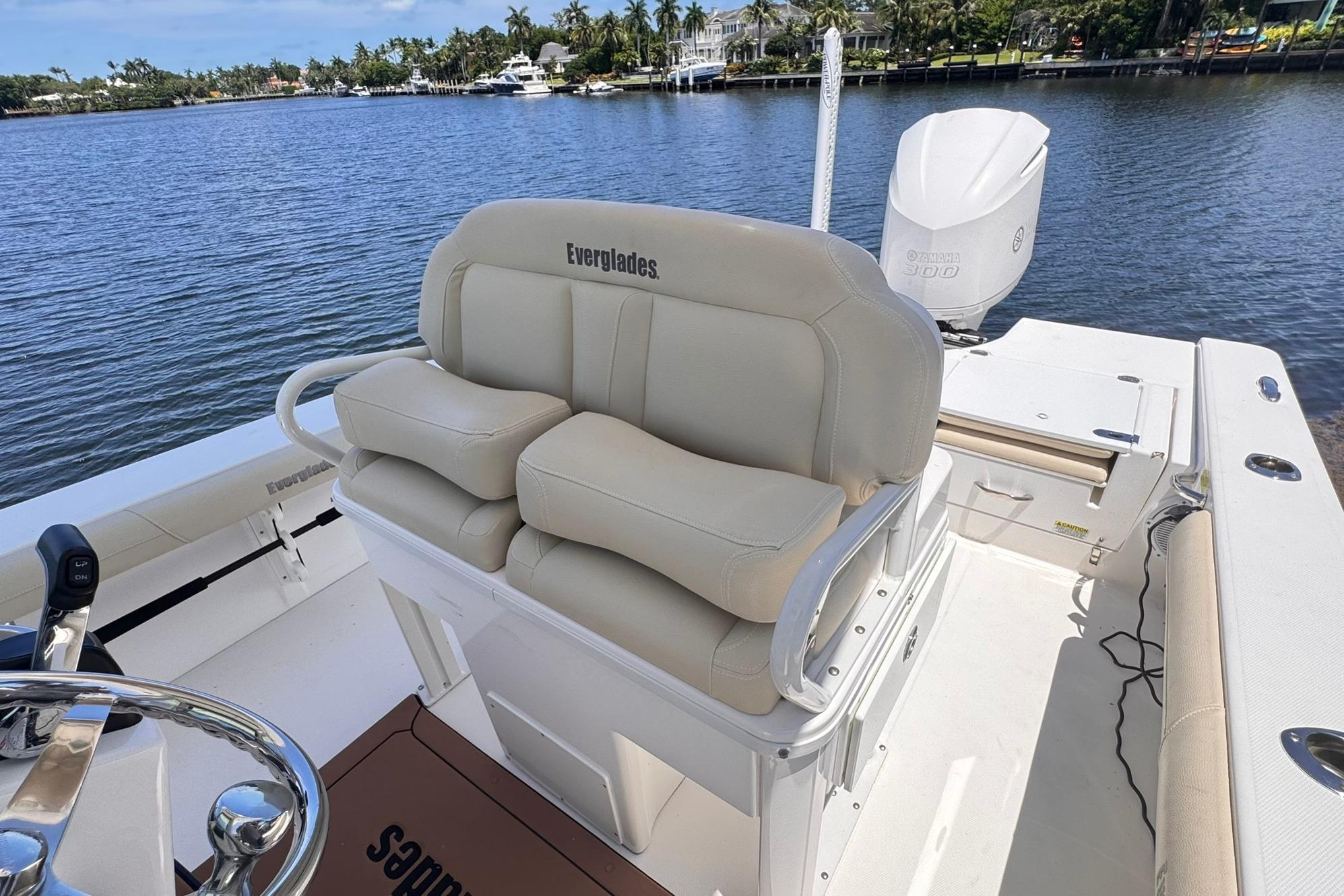 2018 Everglades 253 Center Console boat with beige seating, steering wheel, and Yamaha engine.