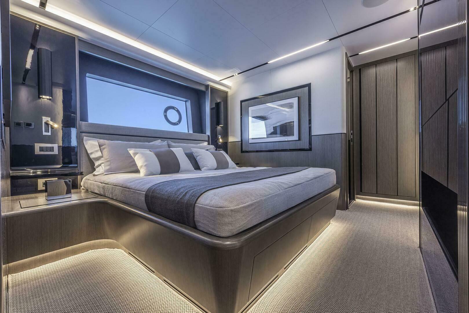 Luxurious bedroom interior on Pearl 82 yacht, 2026 model, featuring modern design and ambient lighting.