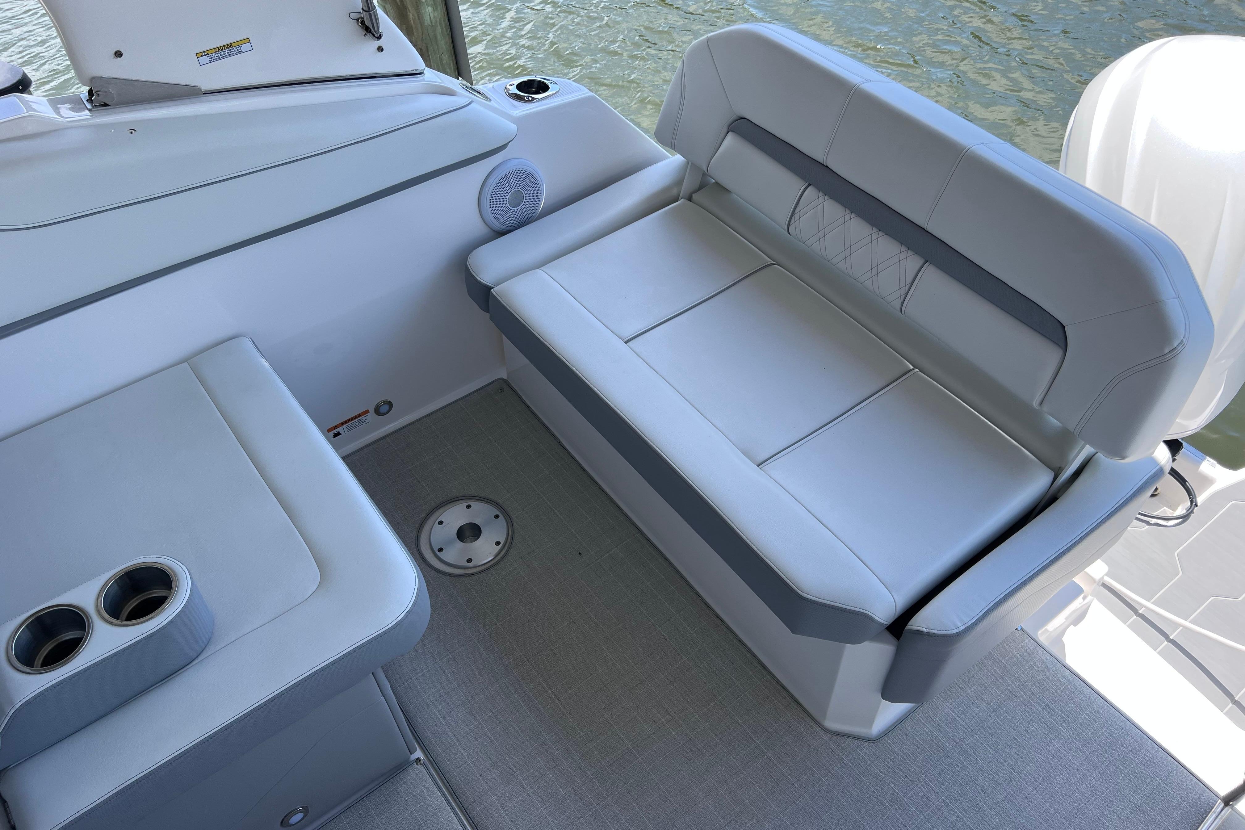 2024 Regal 26 XO boat interior with cushioned seating and cup holders.