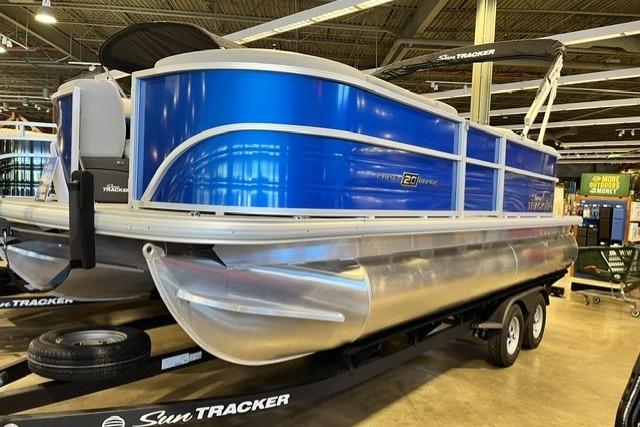 2026 Sun Tracker Party Barge 20 DLX pontoon boat displayed indoors.