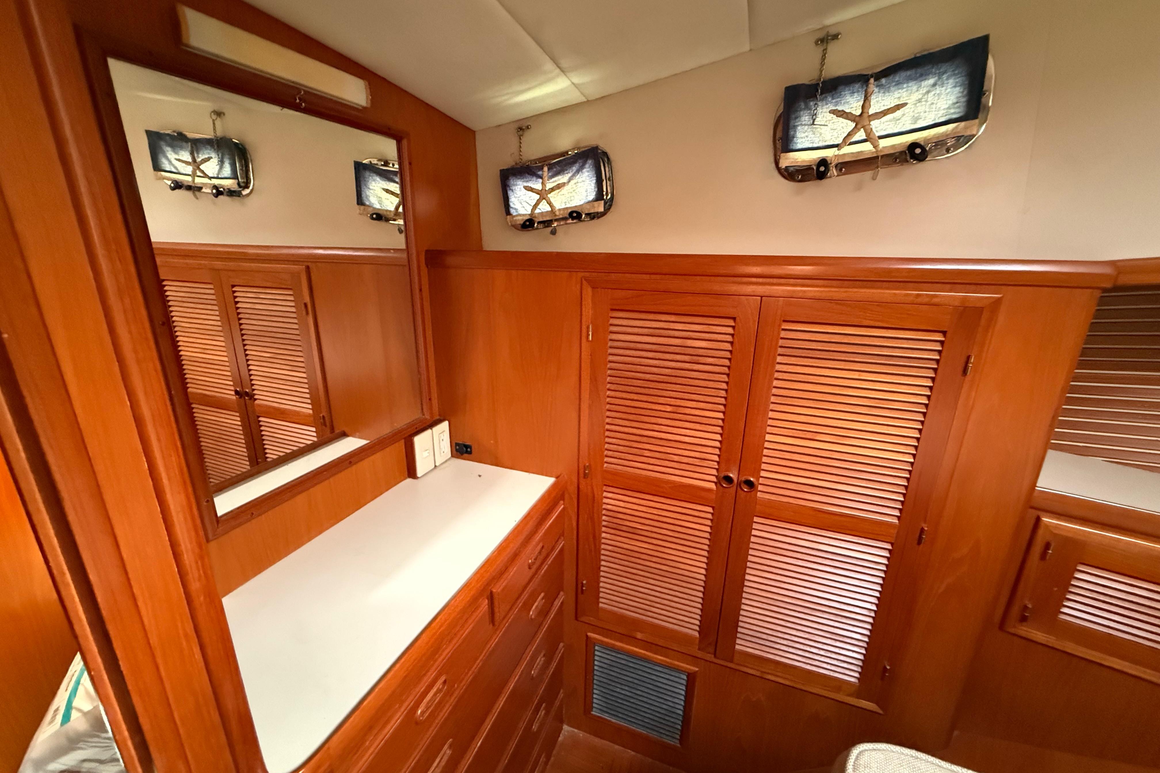 Elegant wooden interior of 2001 Kadey-Krogen 39 yacht with mirror and storage cabinets.