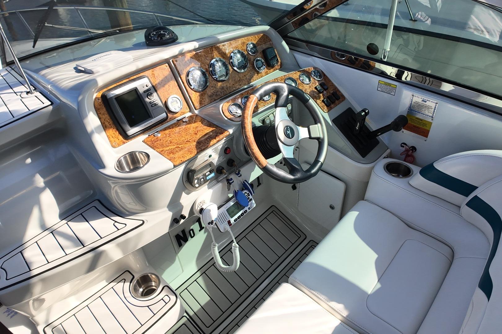 Cockpit of 2007 Formula 330 Sun Sport boat with wood accents and modern controls.