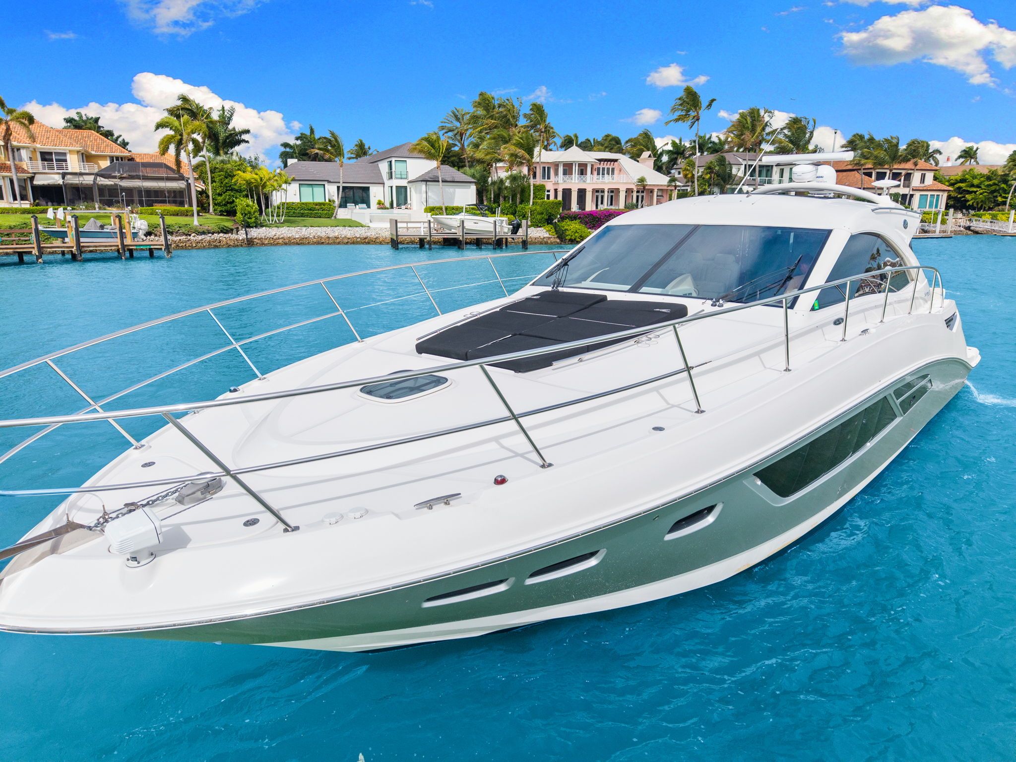 2017 Sea Ray Sundancer 510 on blue water near coastal homes.