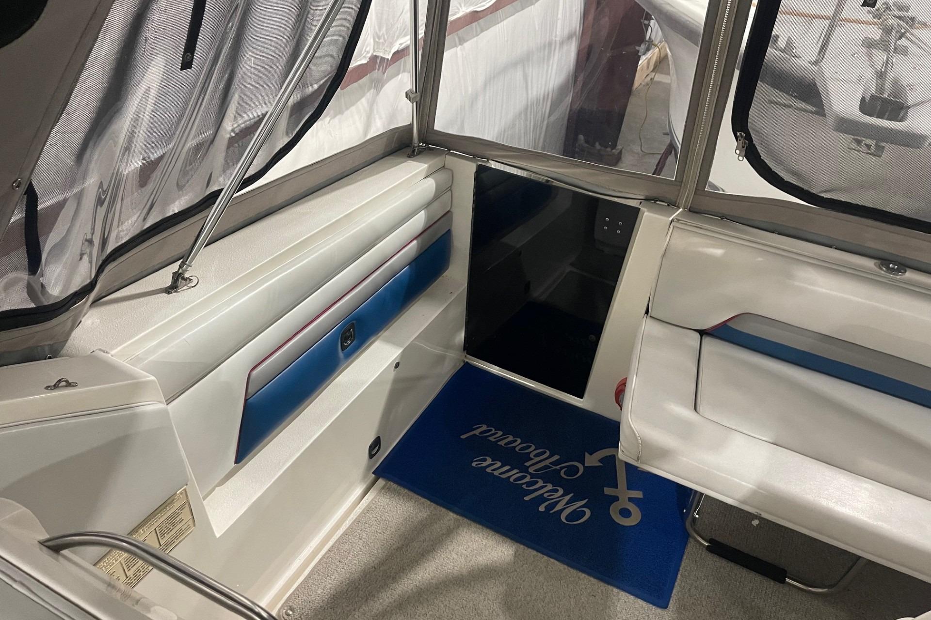 Interior of a 1992 Chaparral Signature 30 boat with seating and welcome mat.