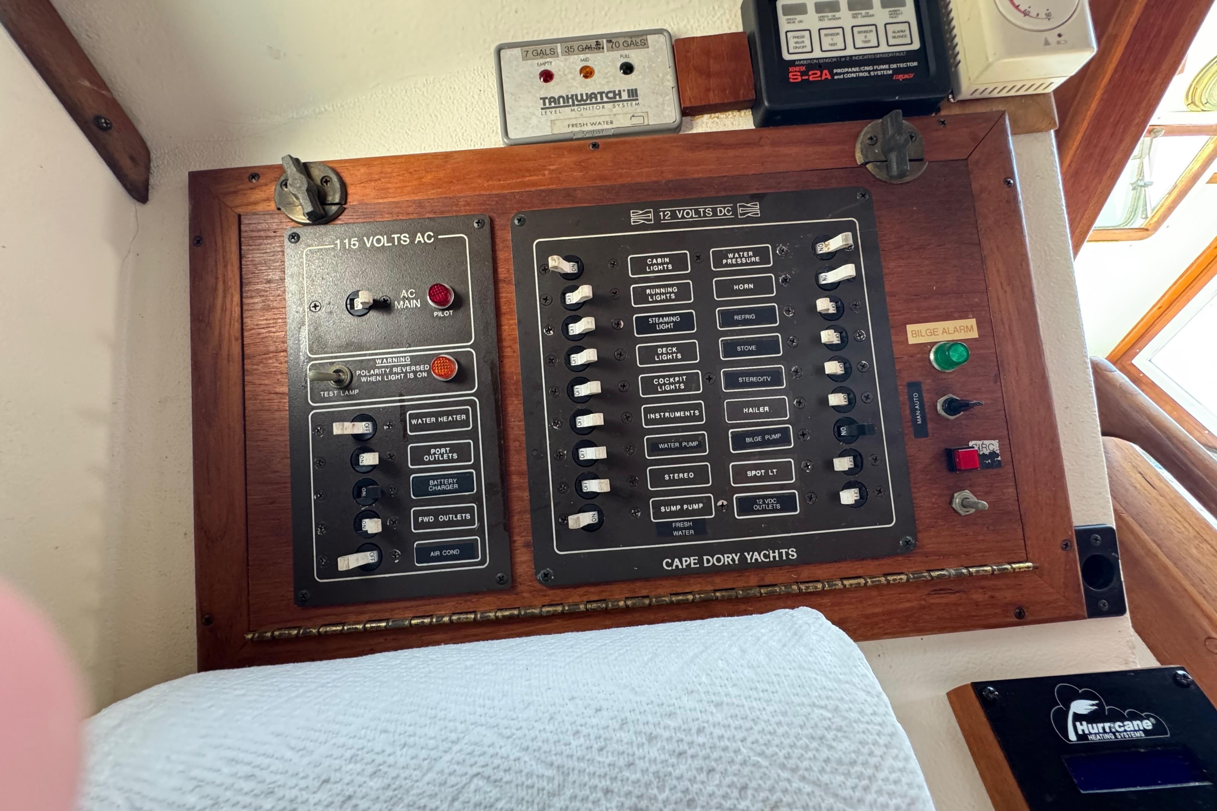Electrical control panel on a 1989 Cape Dory 30 Motorsailer yacht, featuring AC and DC switches.