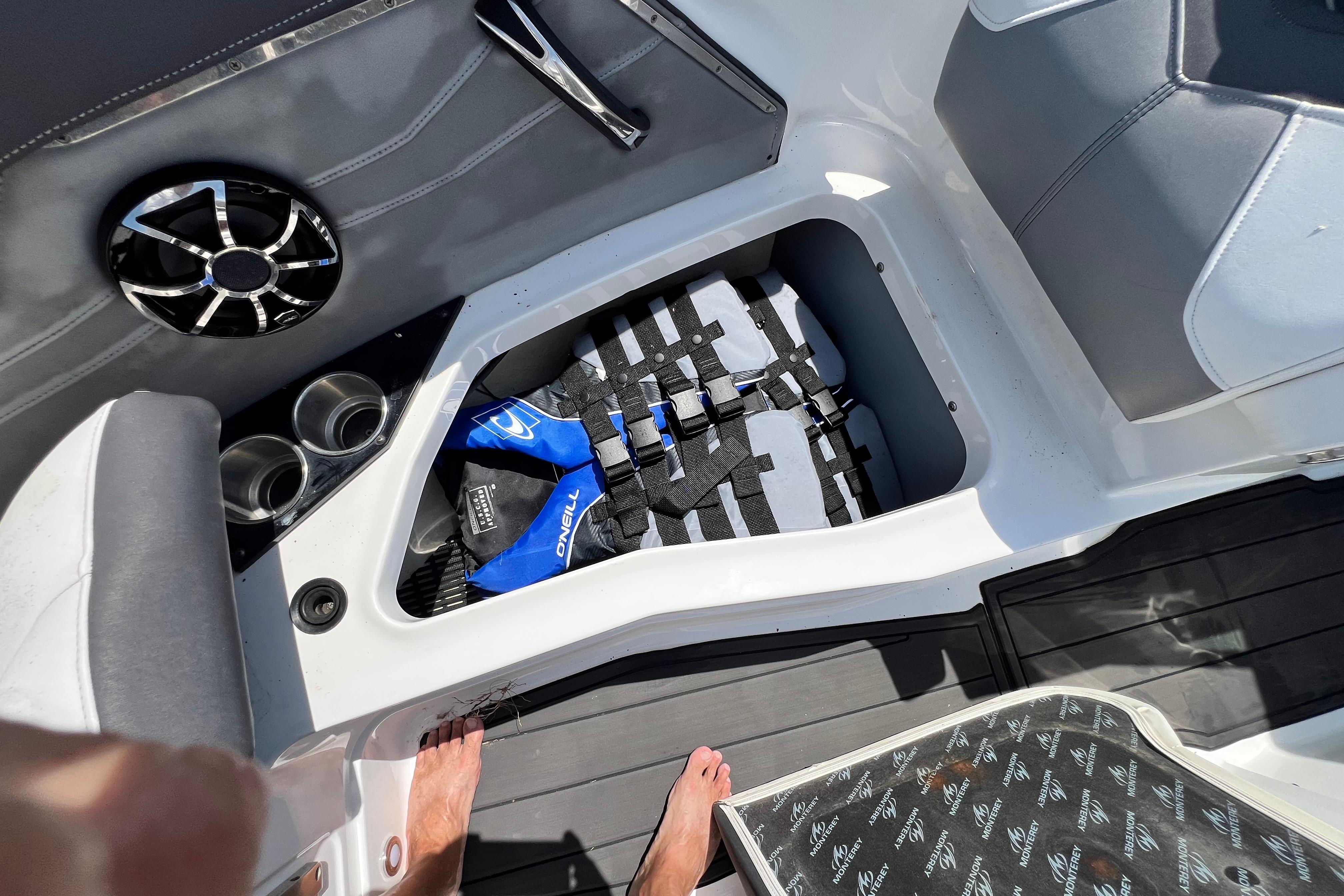 Interior of a 2015 Monterey 268SS Super Sport boat with storage compartment and speaker.