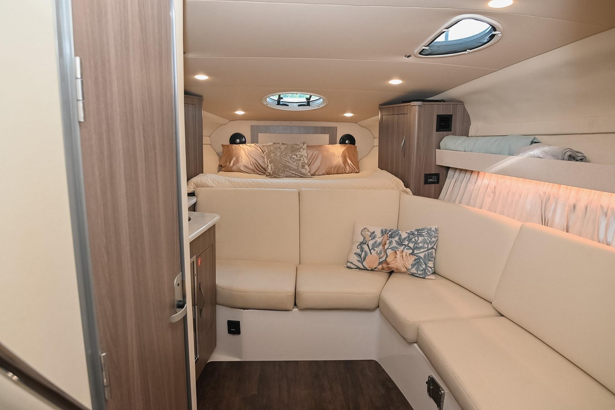 Luxurious interior of 2021 Regal 33 Express yacht with cozy seating and elegant decor.