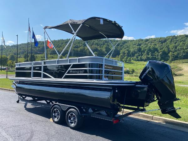 2024 Ranger Reata 223C pontoon boat on trailer, parked outdoors under clear sky.