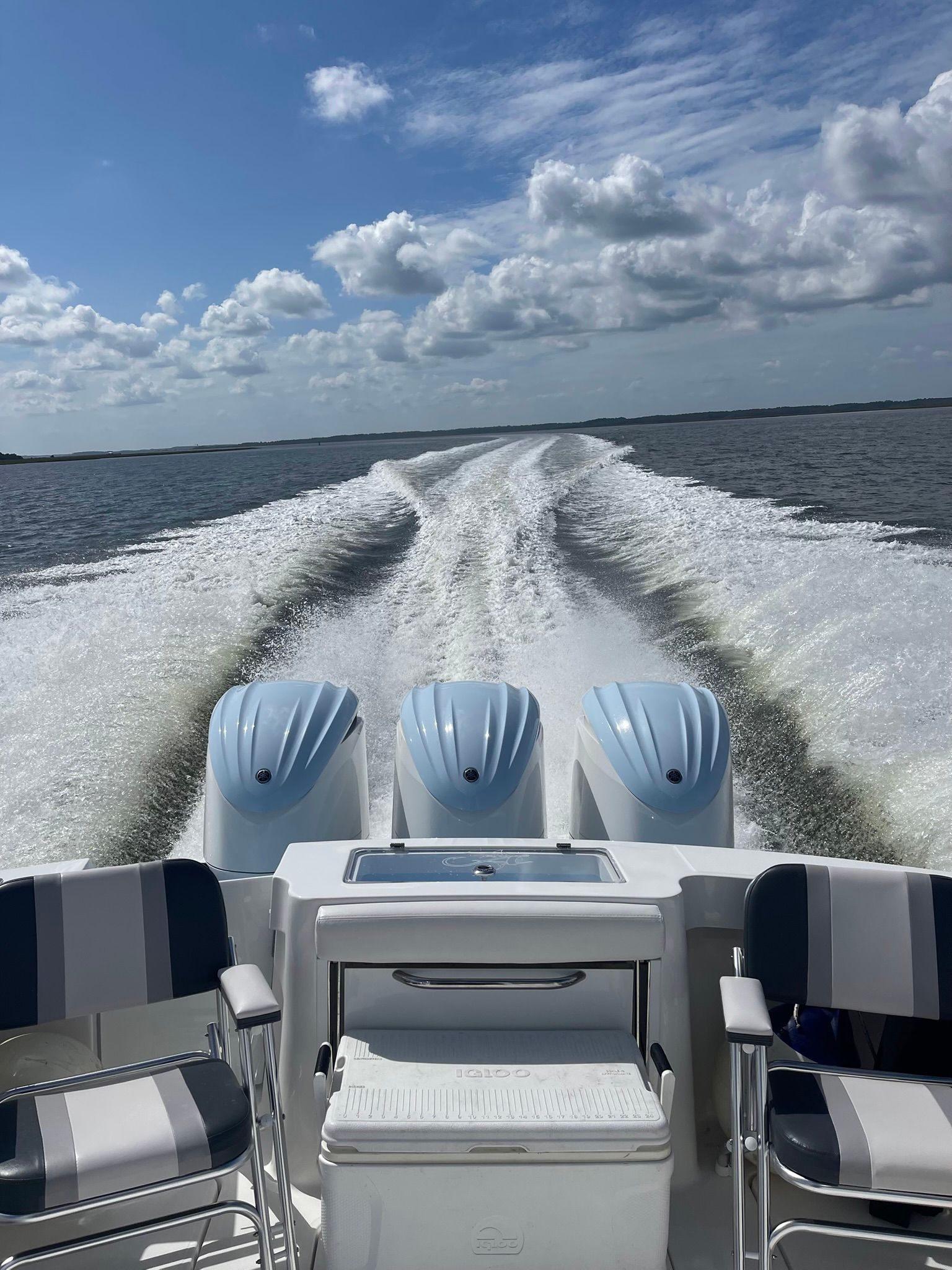 2024 Albemarle 30 Express on the water with three engines and two seats.