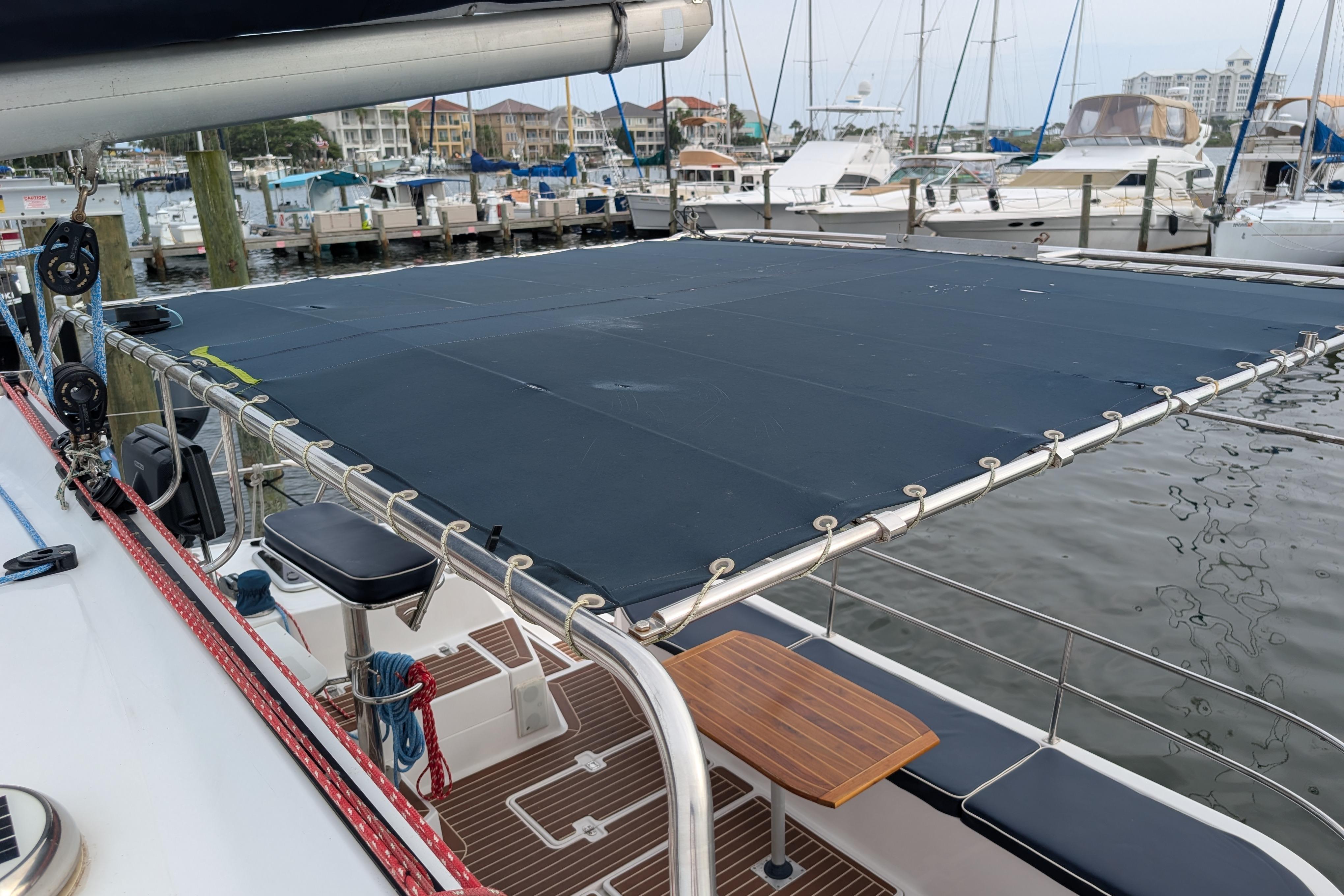 1999 Island Spirit 37 sailboat with covered deck, docked at marina.