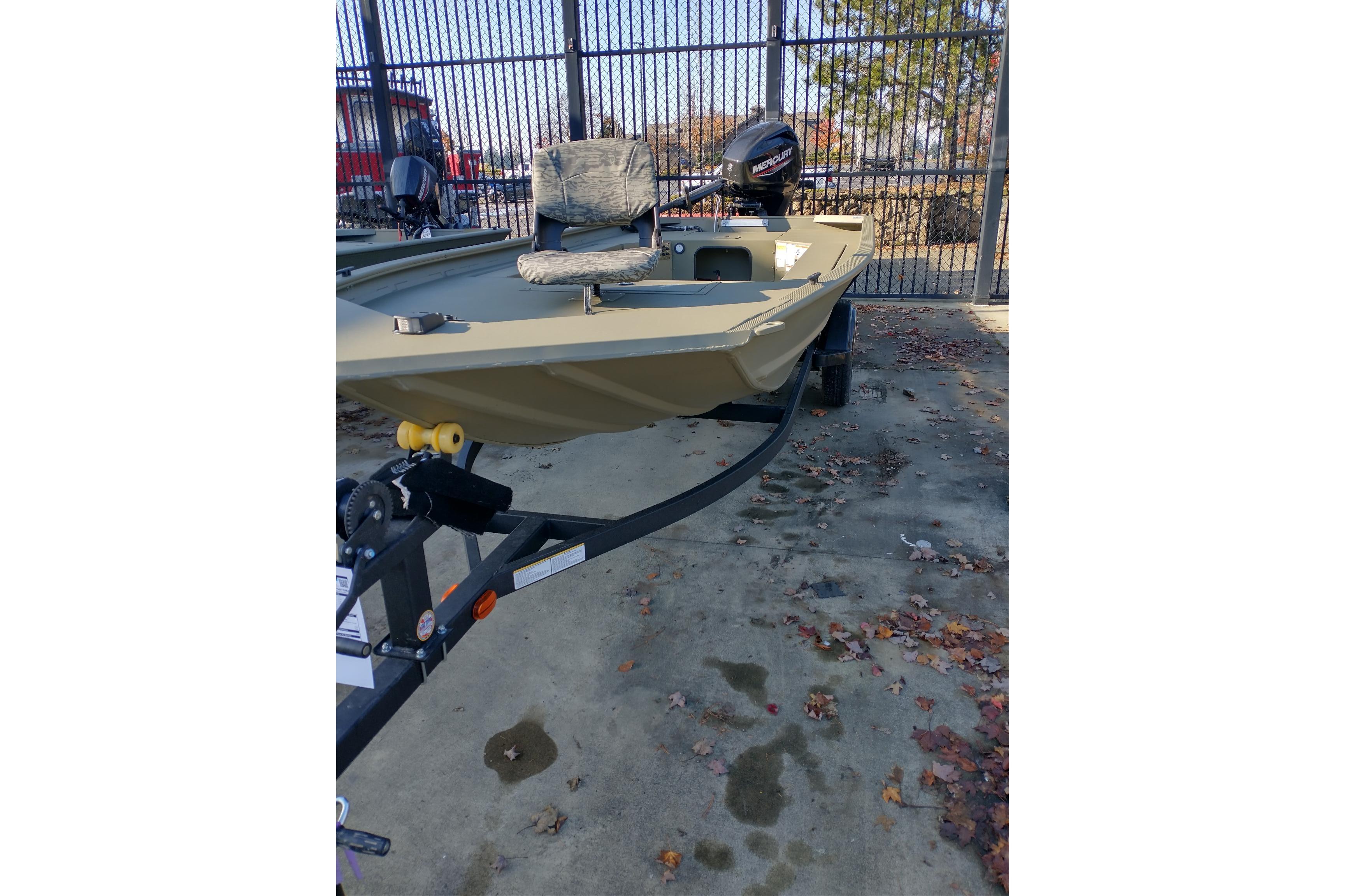 2026 Tracker Grizzly 1654 T Sportsman boat on trailer, outdoor setting.