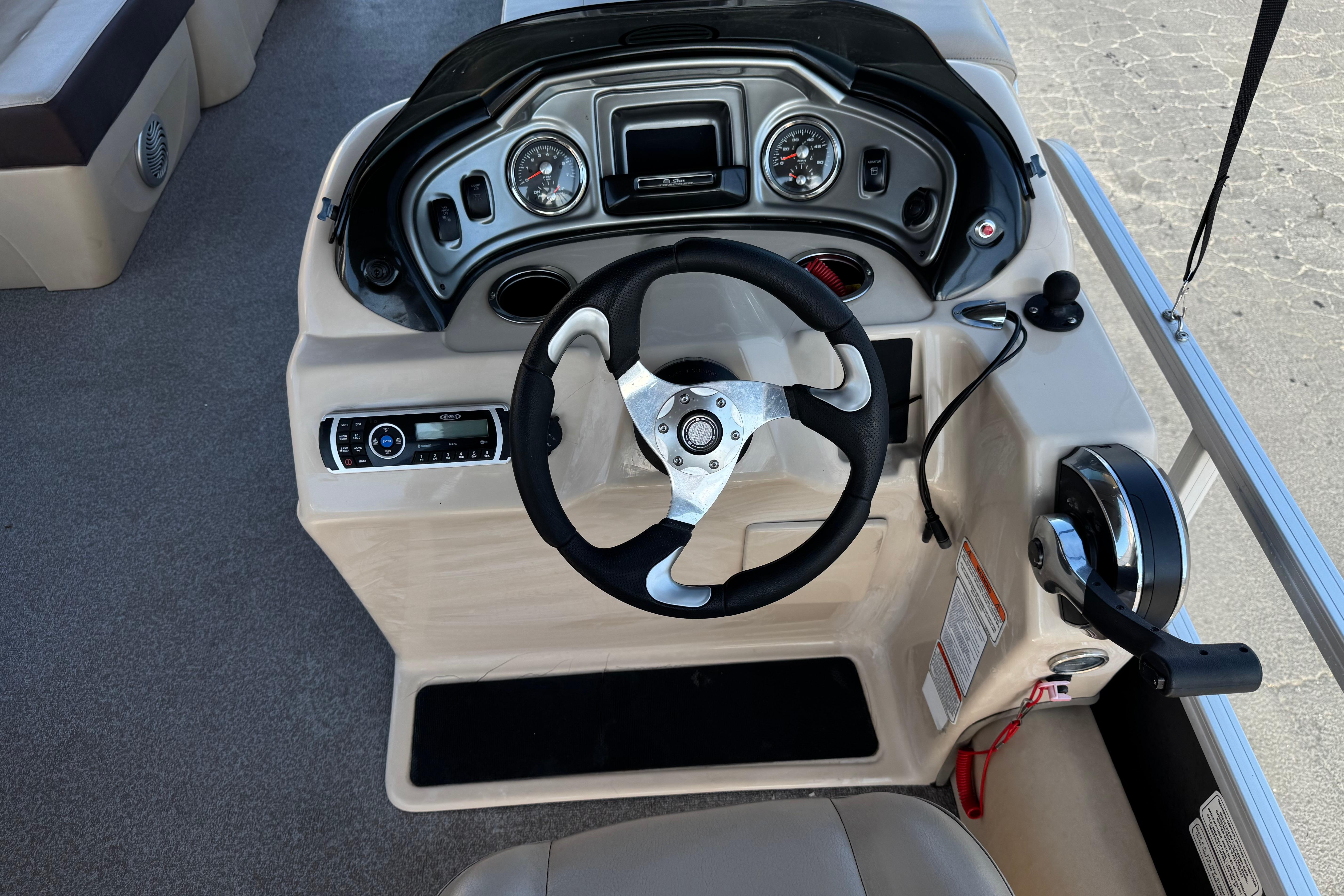 2018 Sun Tracker SportFish 22 DLX boat dashboard with steering wheel and controls.