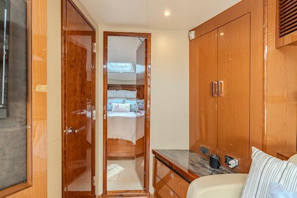 Luxurious interior of 2016 Sea Ray Sundancer 510 yacht with wooden cabinetry and cozy bedroom.