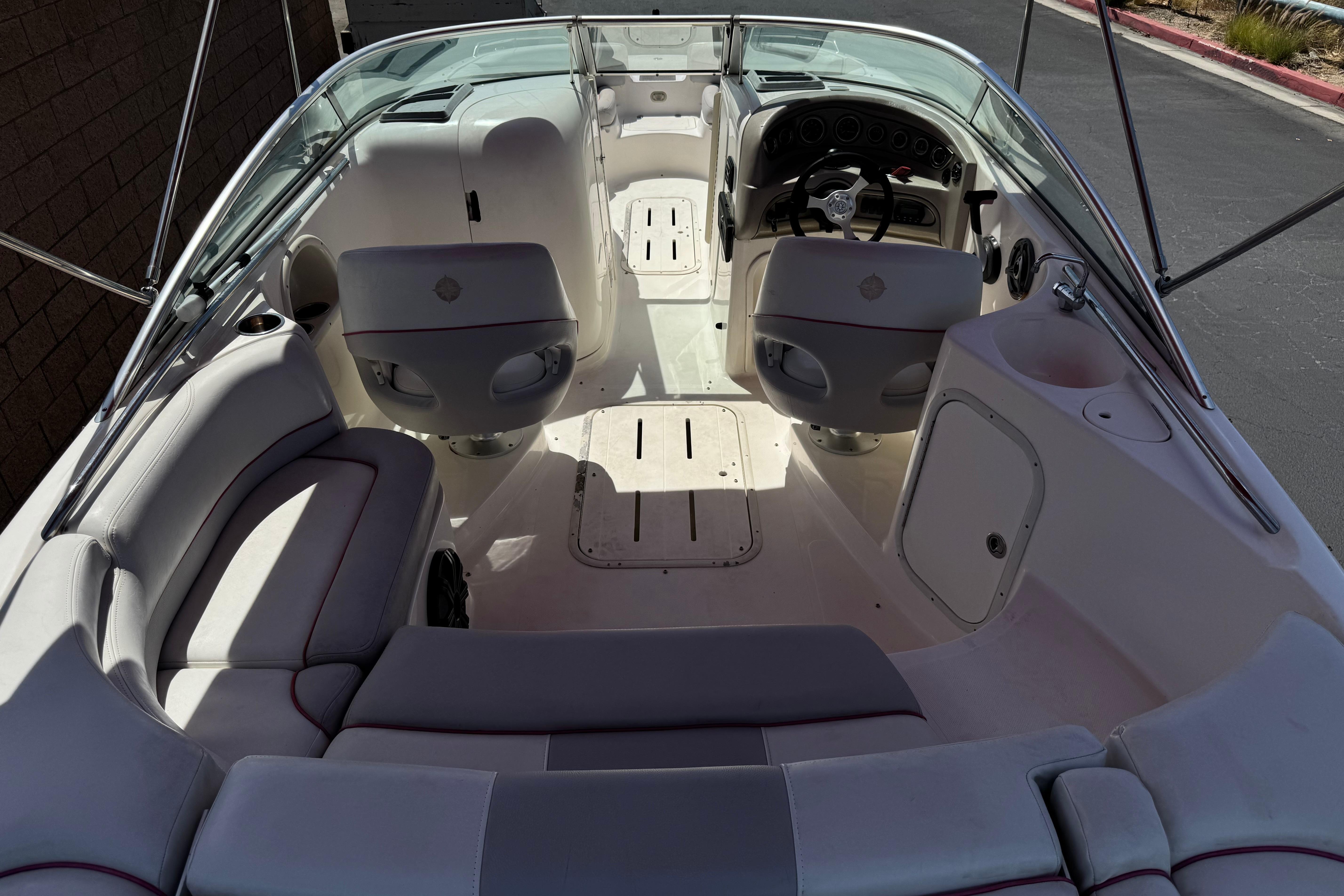 Interior of a 2010 Bryant 255 boat with seating and steering wheel.