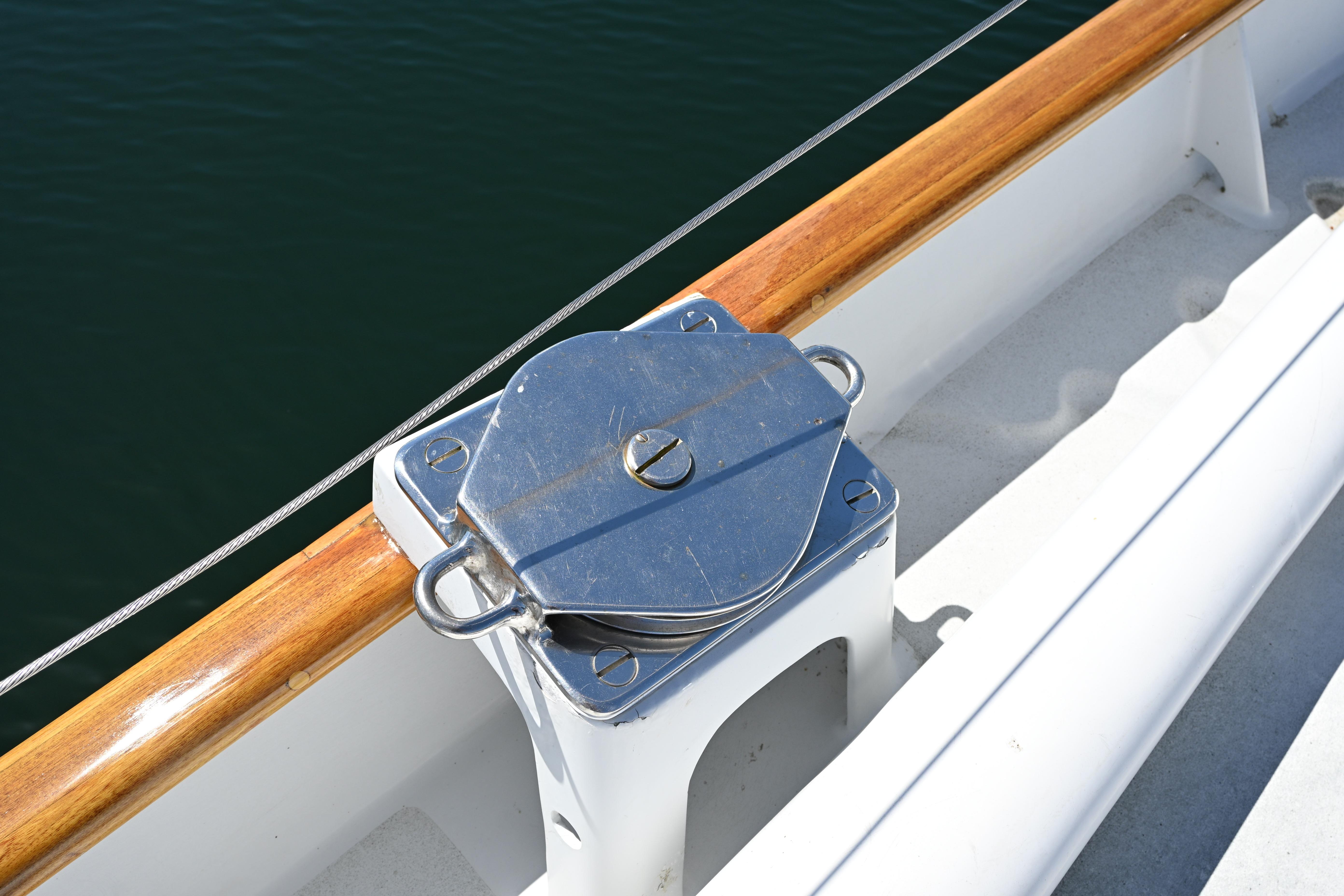 Deck detail of a 1968 Abeking & Rasmussen Tripp 74 yacht, featuring polished metal hardware.