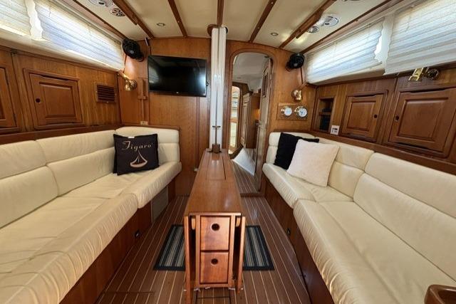 Luxurious interior of 2002 Saga 43 yacht with elegant wood finish and plush seating.
