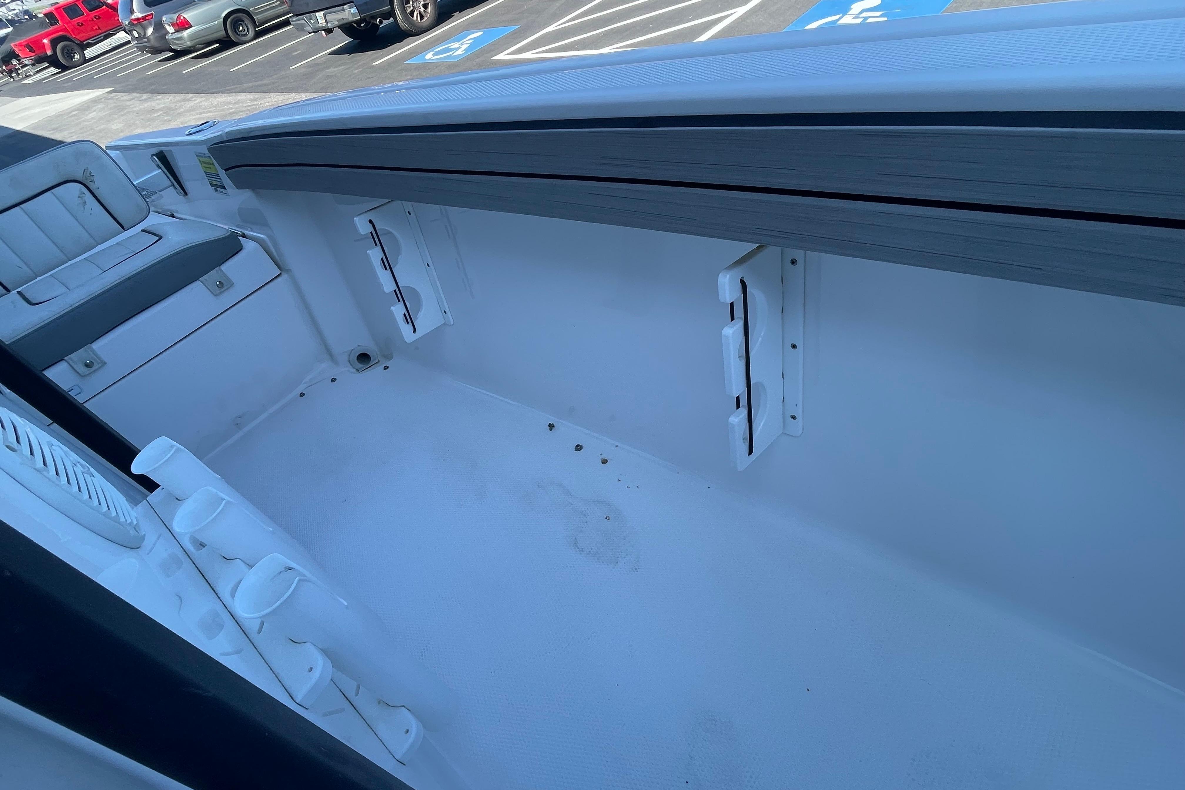 2021 Yamaha Boats 195 FSH Sport interior, showcasing seating and storage features.