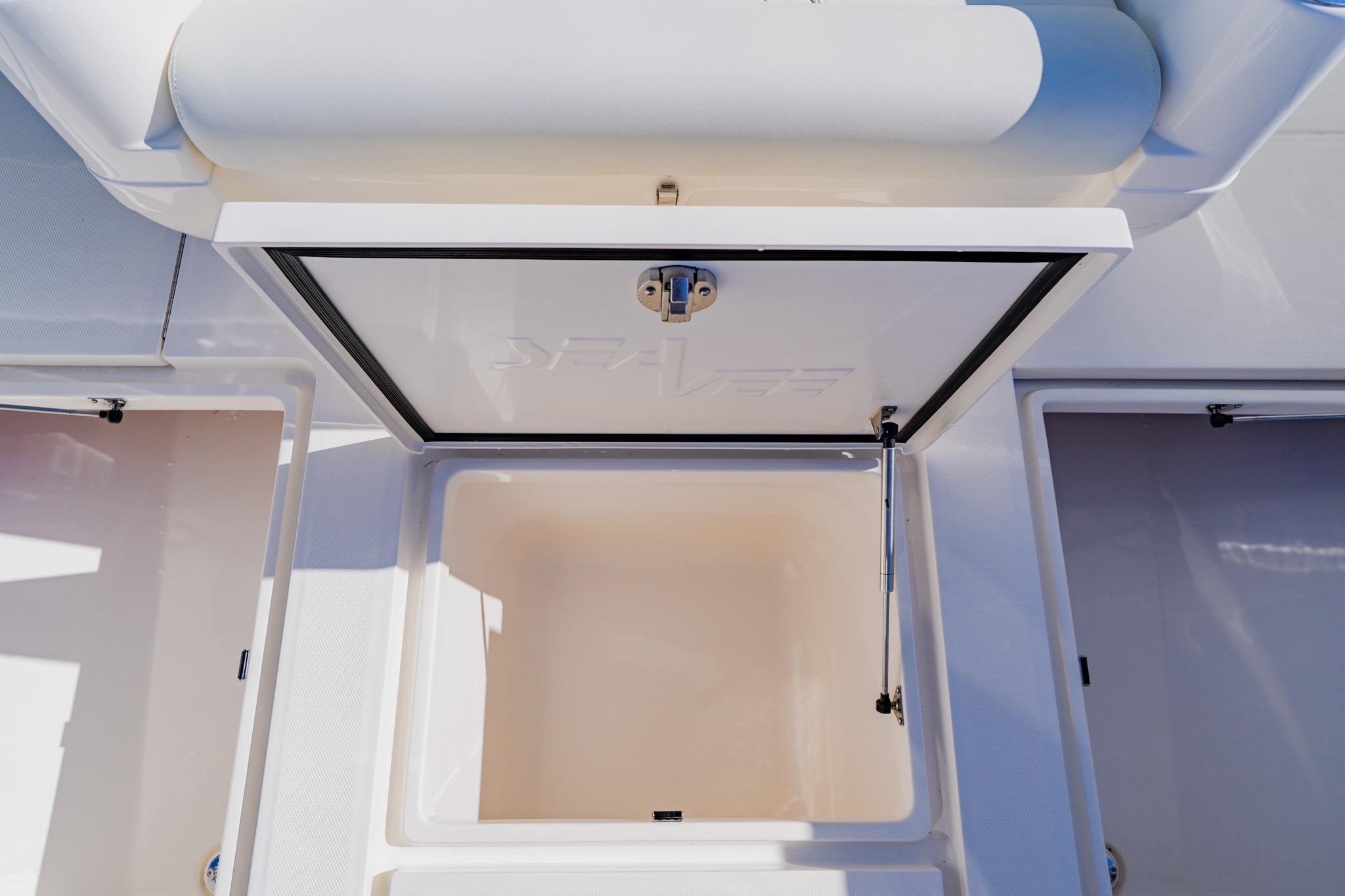 Open storage compartment on 2025 SeaVee 370Z boat, showcasing interior space.