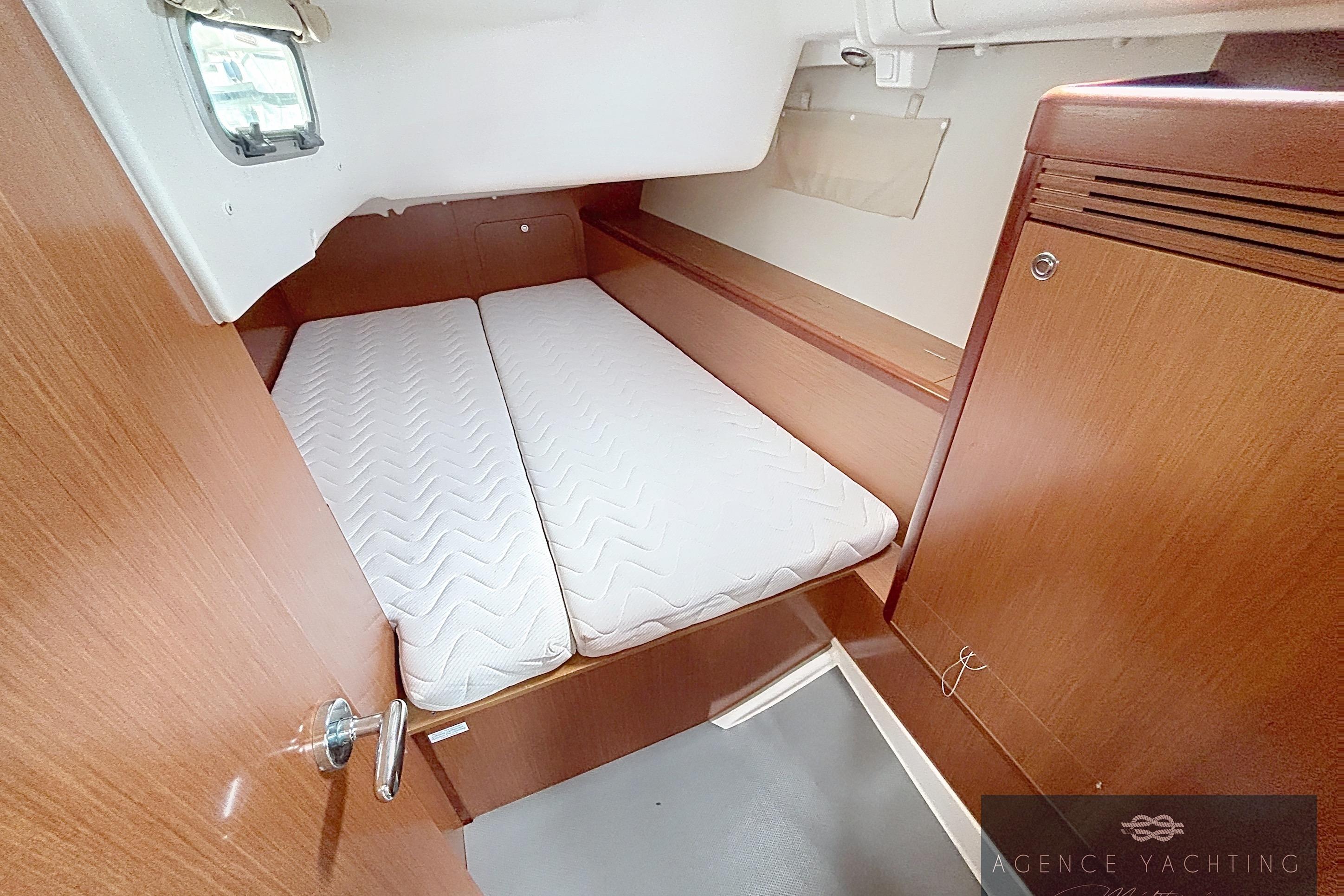 2008 Beneteau Oceanis 40 cabin interior with wooden finish and comfortable bedding.