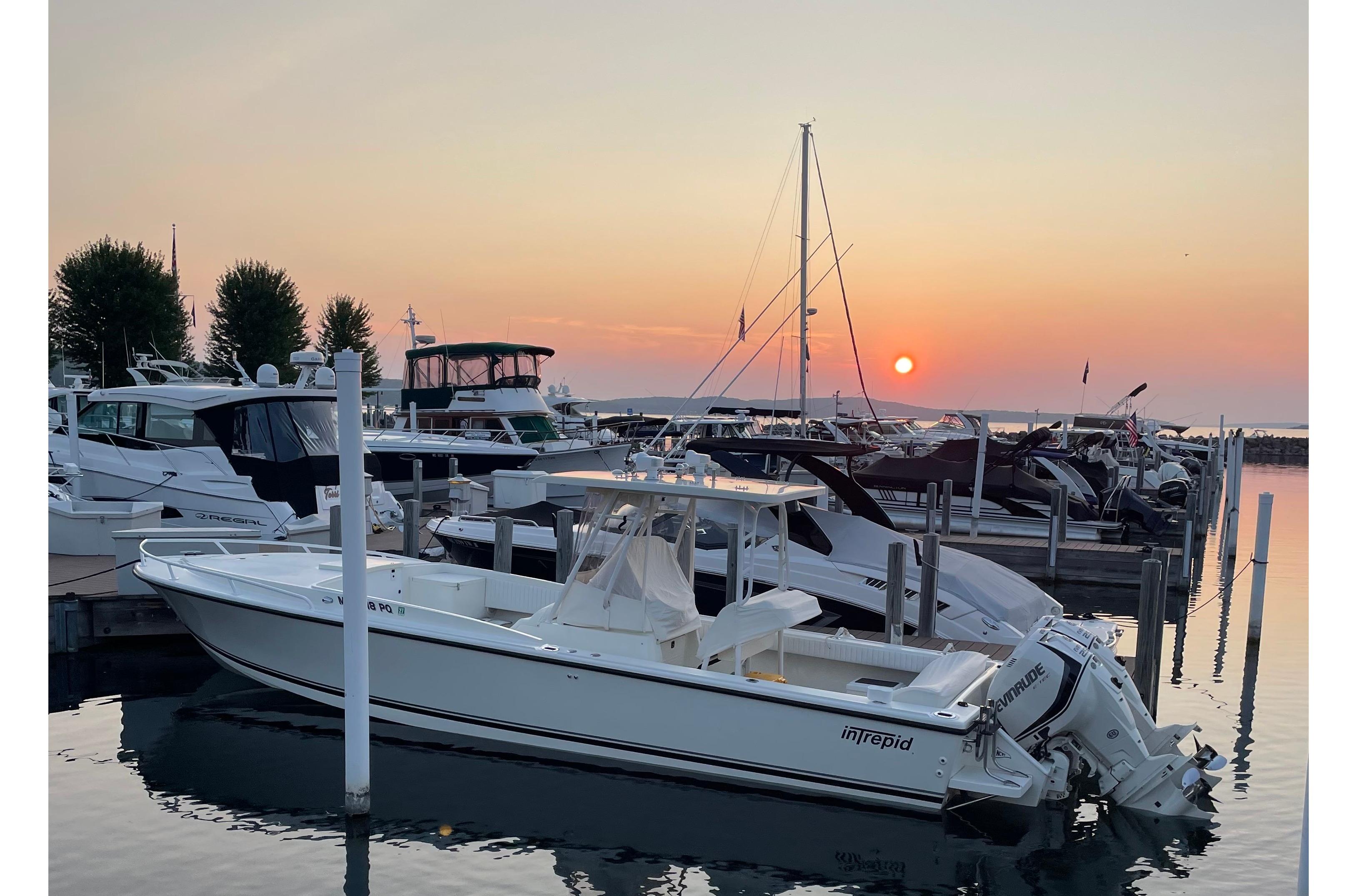 1994 Intrepid 30 Open Cuddy boat docked at sunset in a serene marina.
