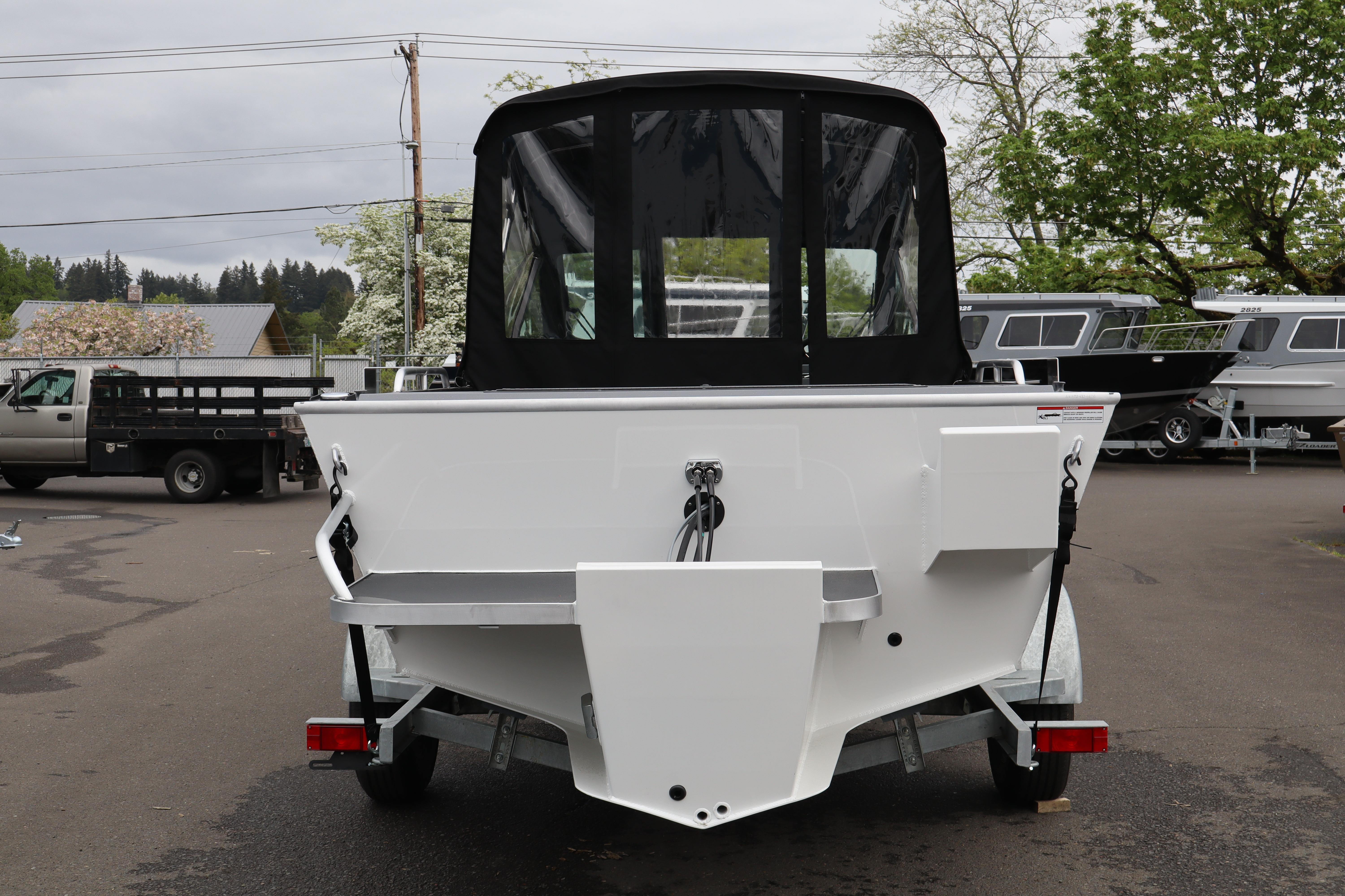 2026 Alumaweld Stryker X202 boat on trailer, rear view in outdoor setting.