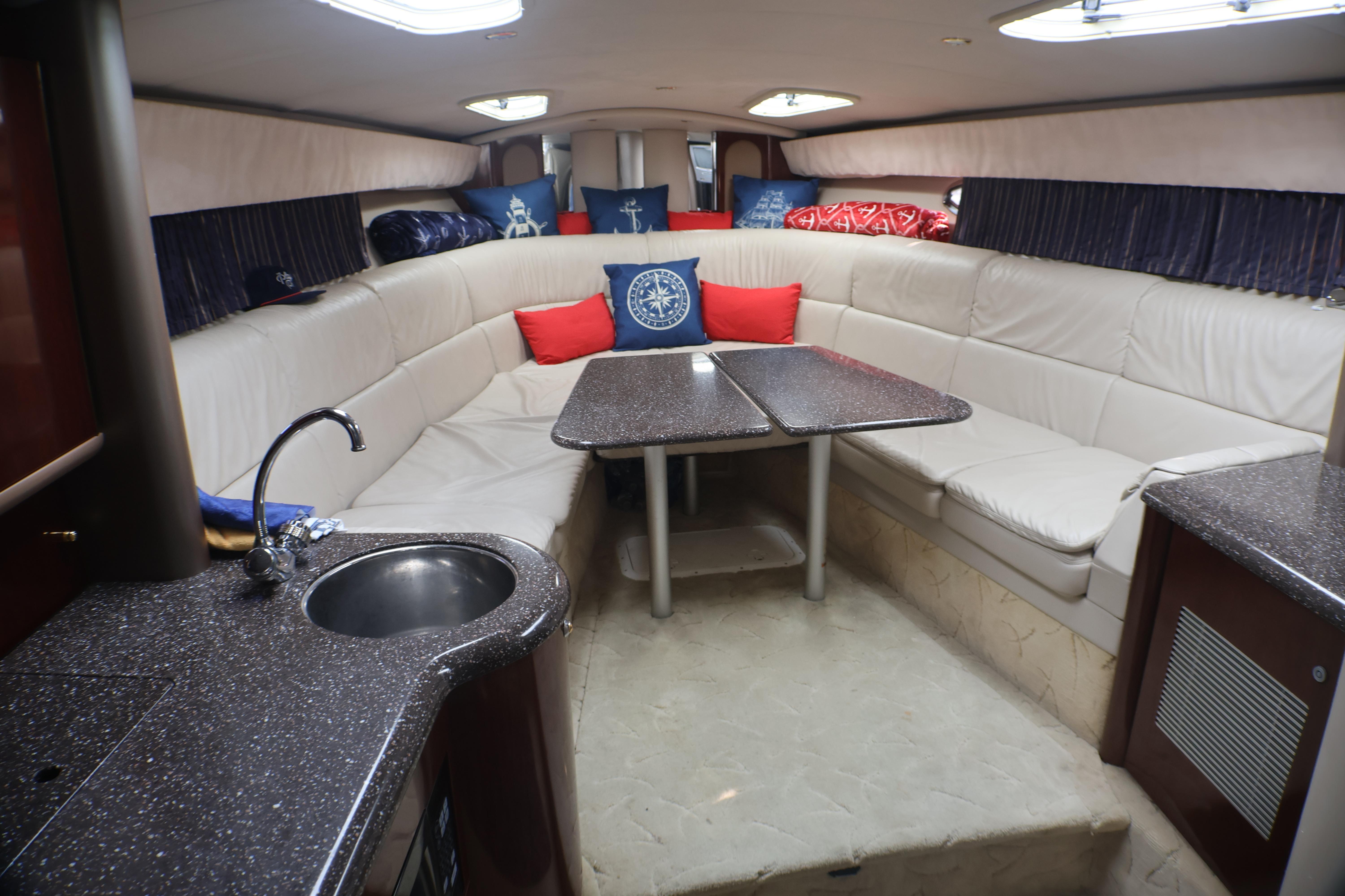 Luxurious interior of a 2003 Formula 400 Super Sport yacht with plush seating and kitchenette.
