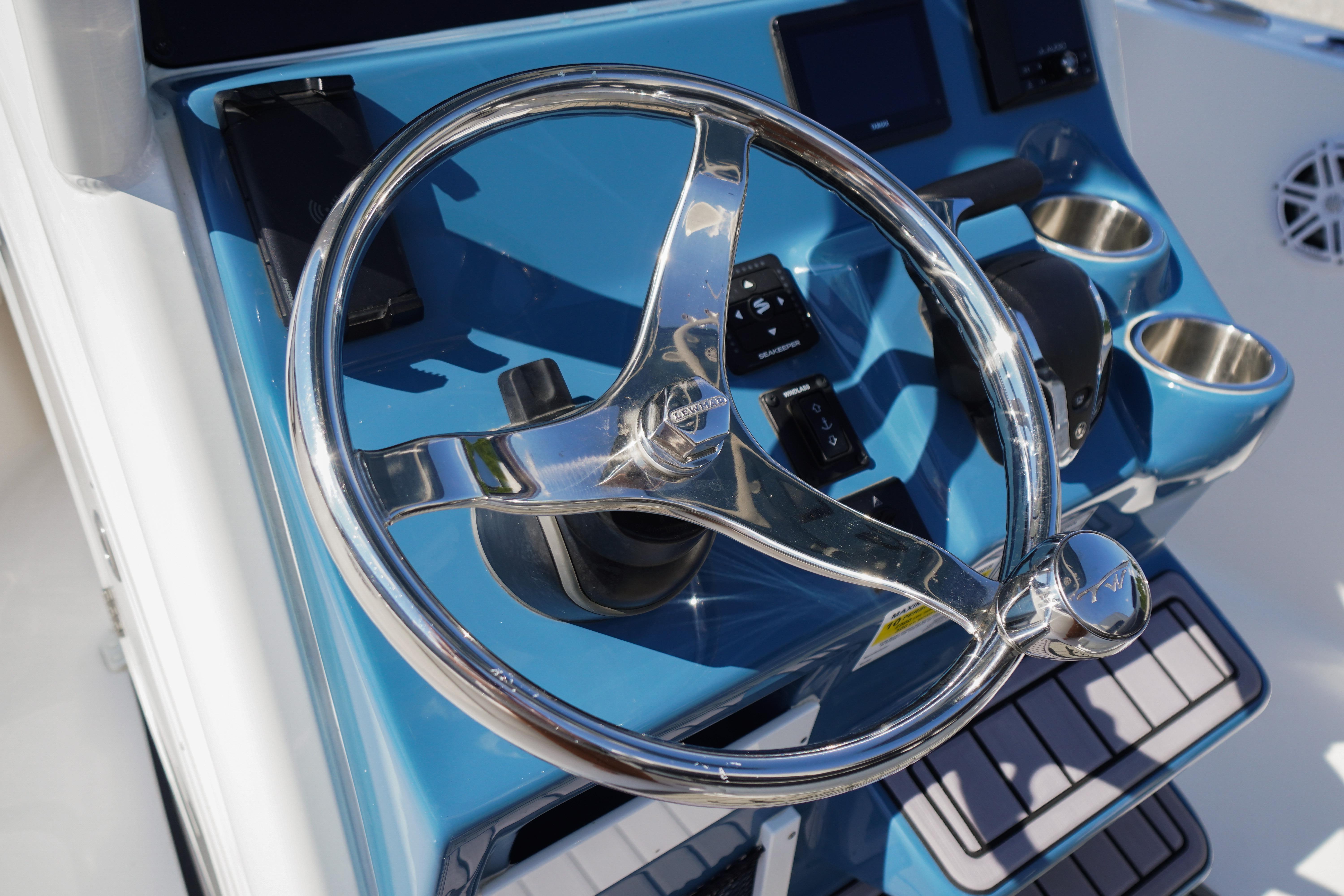 Steering wheel of 2025 Tidewater 232 SS boat, featuring a sleek blue dashboard design.