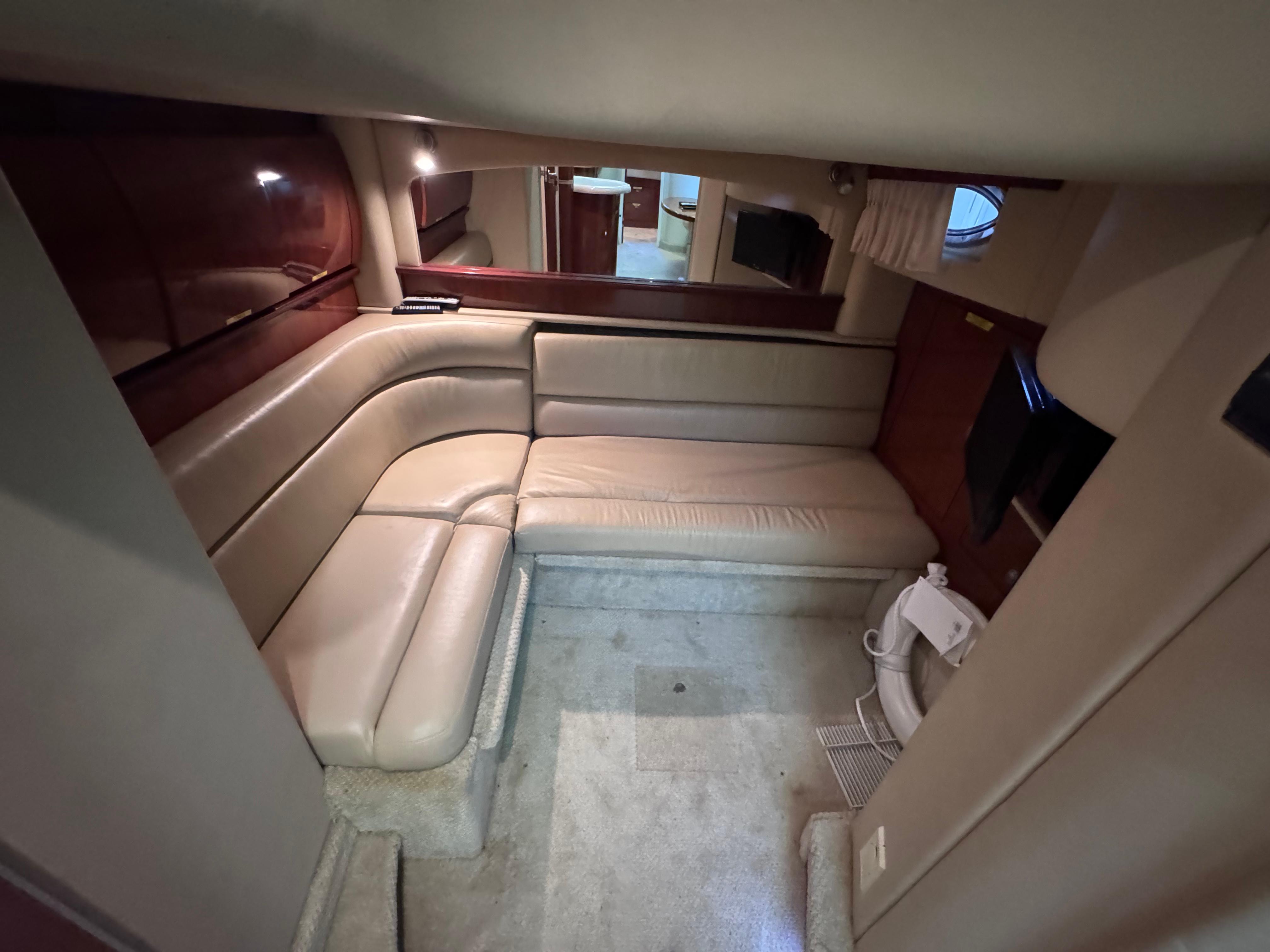 Interior of 2004 Sea Ray 420 Sundancer yacht with beige seating and modern amenities.