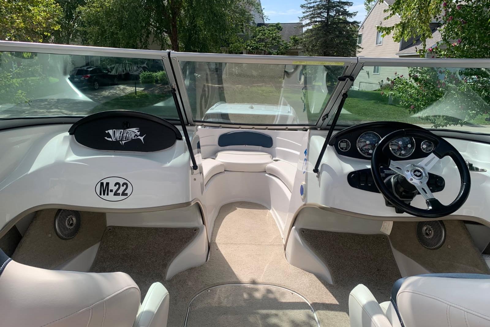 Interior view of 2014 Four Winns 190 Horizon boat, featuring steering wheel and dashboard.