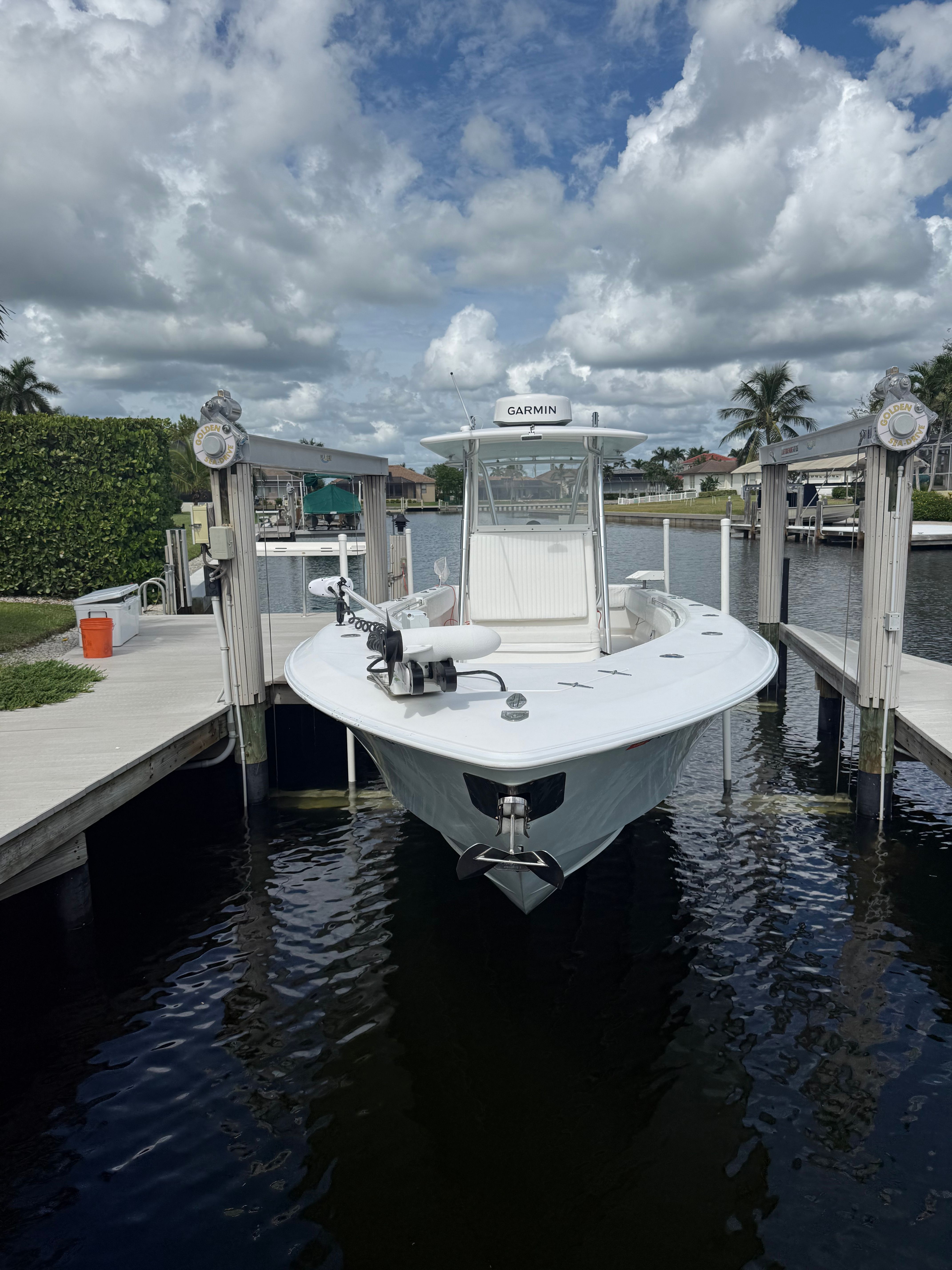 2012 Contender 32 ST boat docked under cloudy sky.